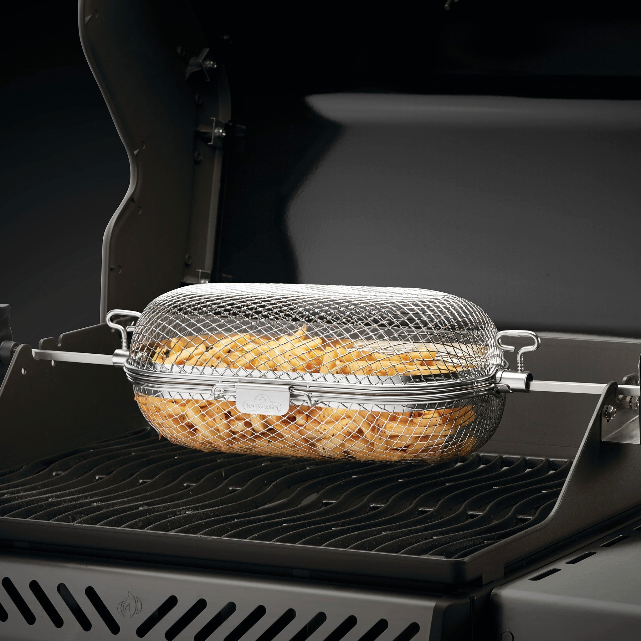 A mesh basket filled with fries is placed on a grill rack, ready for cooking.