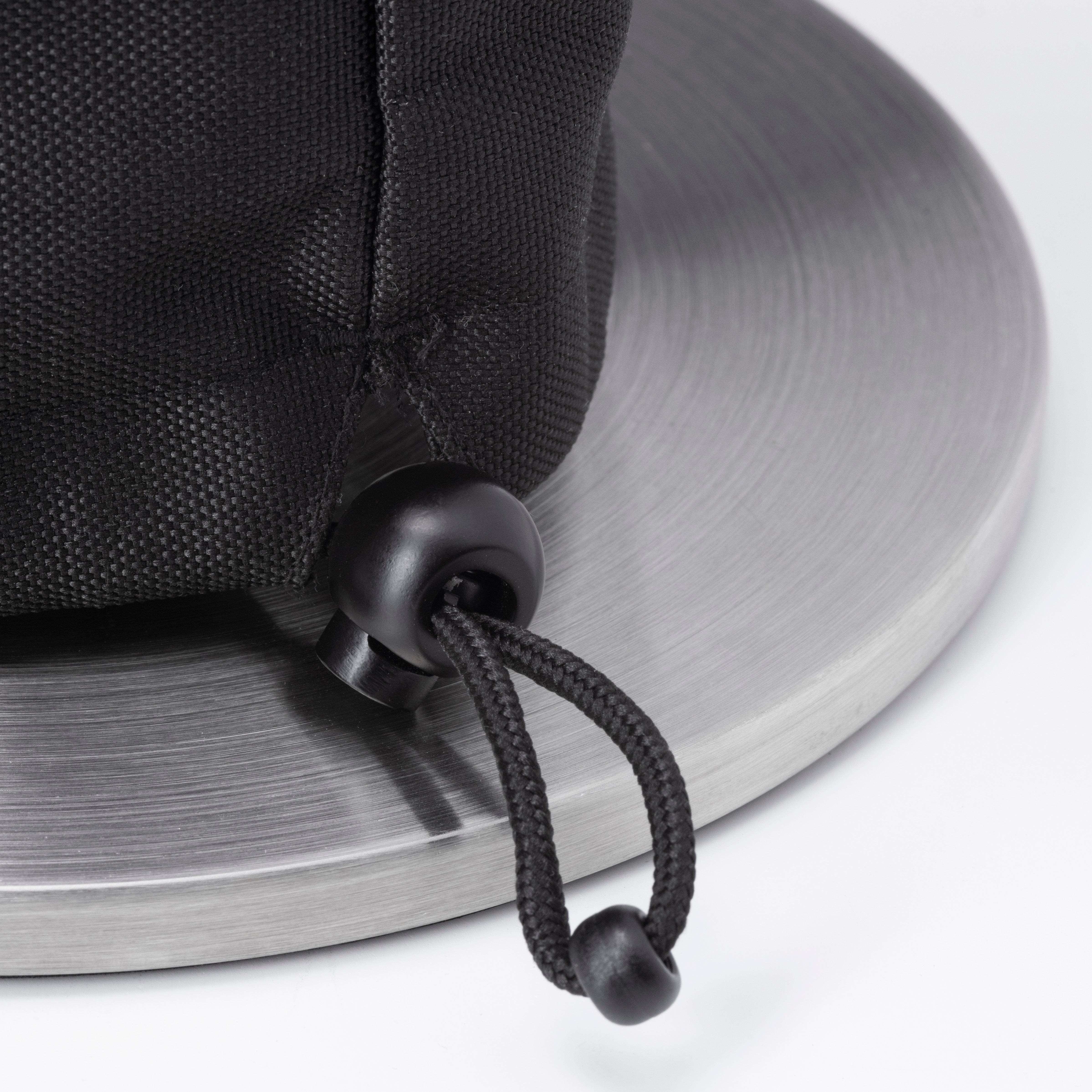 Close-up of the black drawstring with toggle on the textured, water-repellent material of the Höfats SPIN 1500 Cover, resting on a metallic surface.