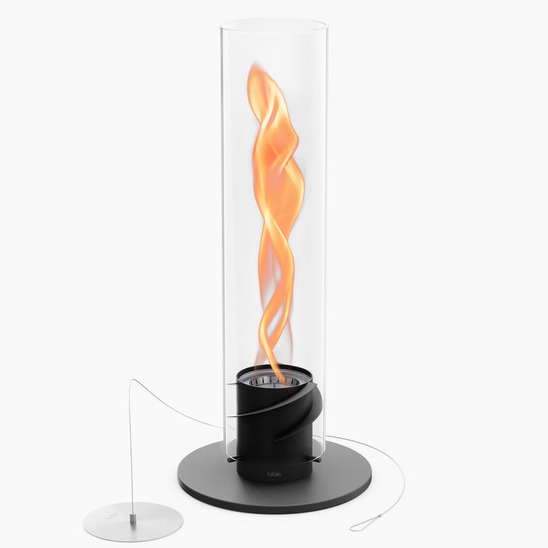 The Höfats SPIN 1500 Tabletop Fireplace Black is a vertical glass flame lamp featuring a black base, which emits an orange, twisting flame-like light within its decorative glass cylinder fueled by bioethanol.