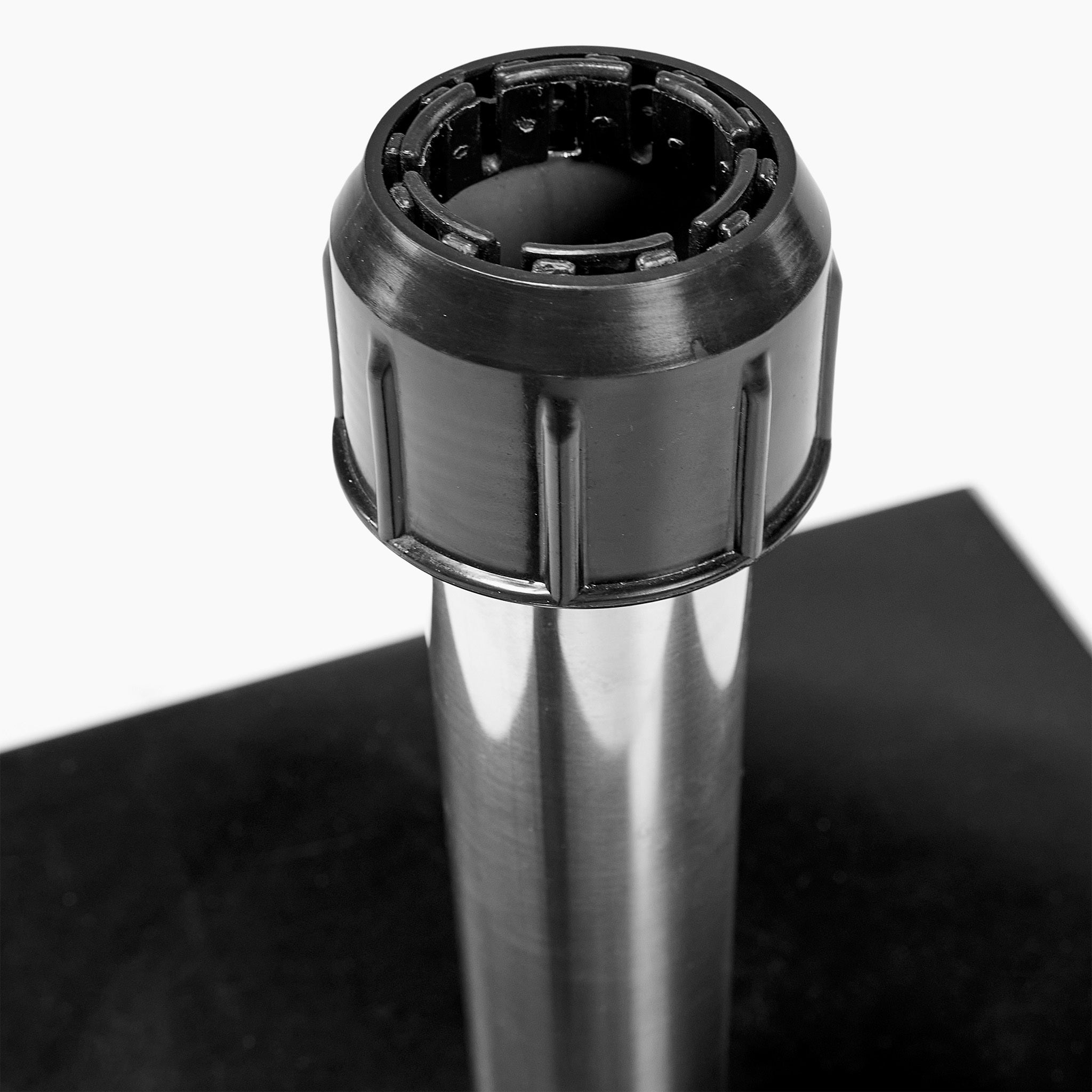 Close-up of a metal pipe with a black plastic cap fitting on top, set against the sleek Rome Polished Black Granite 40KG Parasol Base and a black and white background.