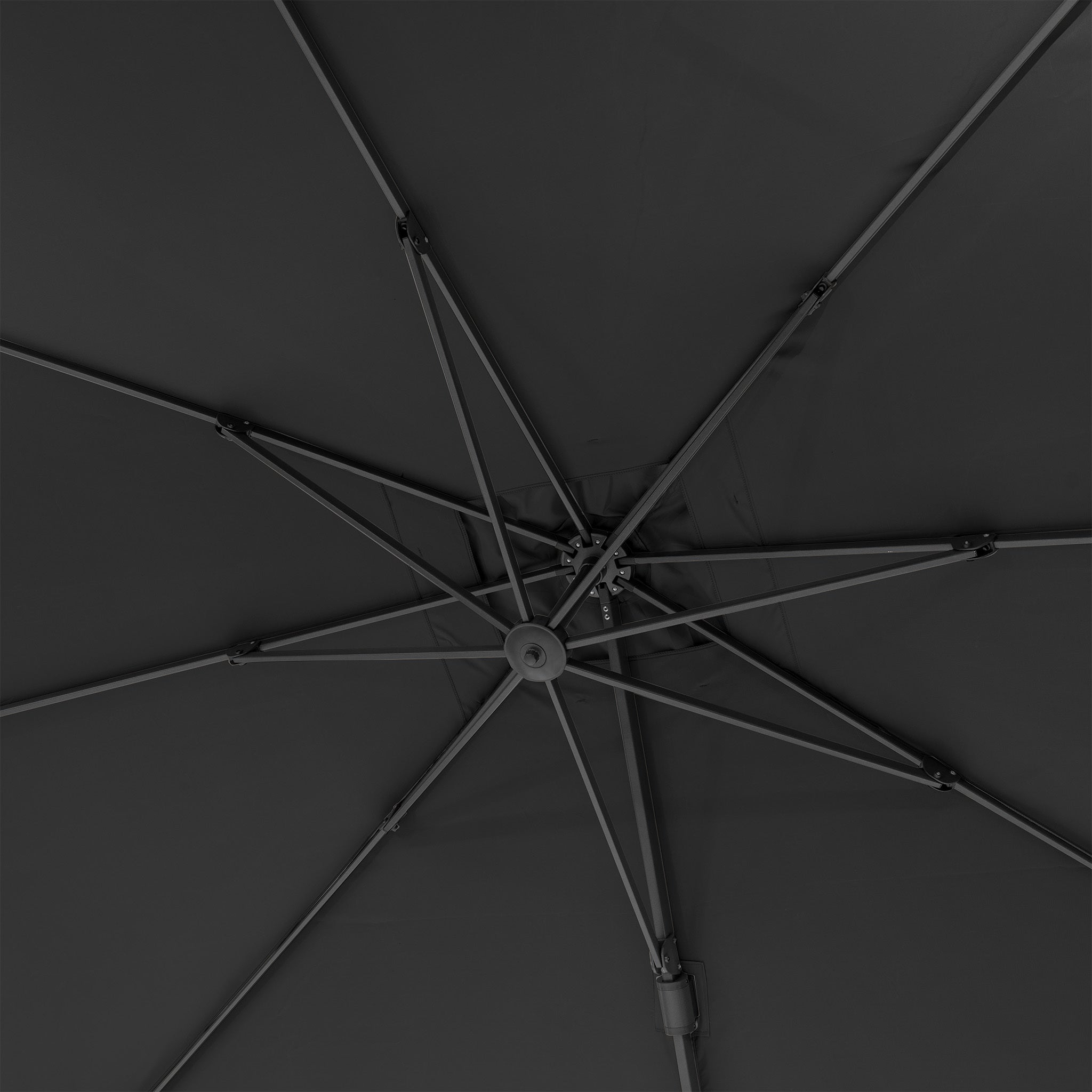 Close-up of a dark umbrella's metal frame and spokes from underneath, highlighted by the premium fabric of the Pacific Lifestyle Challenger T2 3.5m x 2.6m Rectangular Cantilever Parasol in Anthracite.