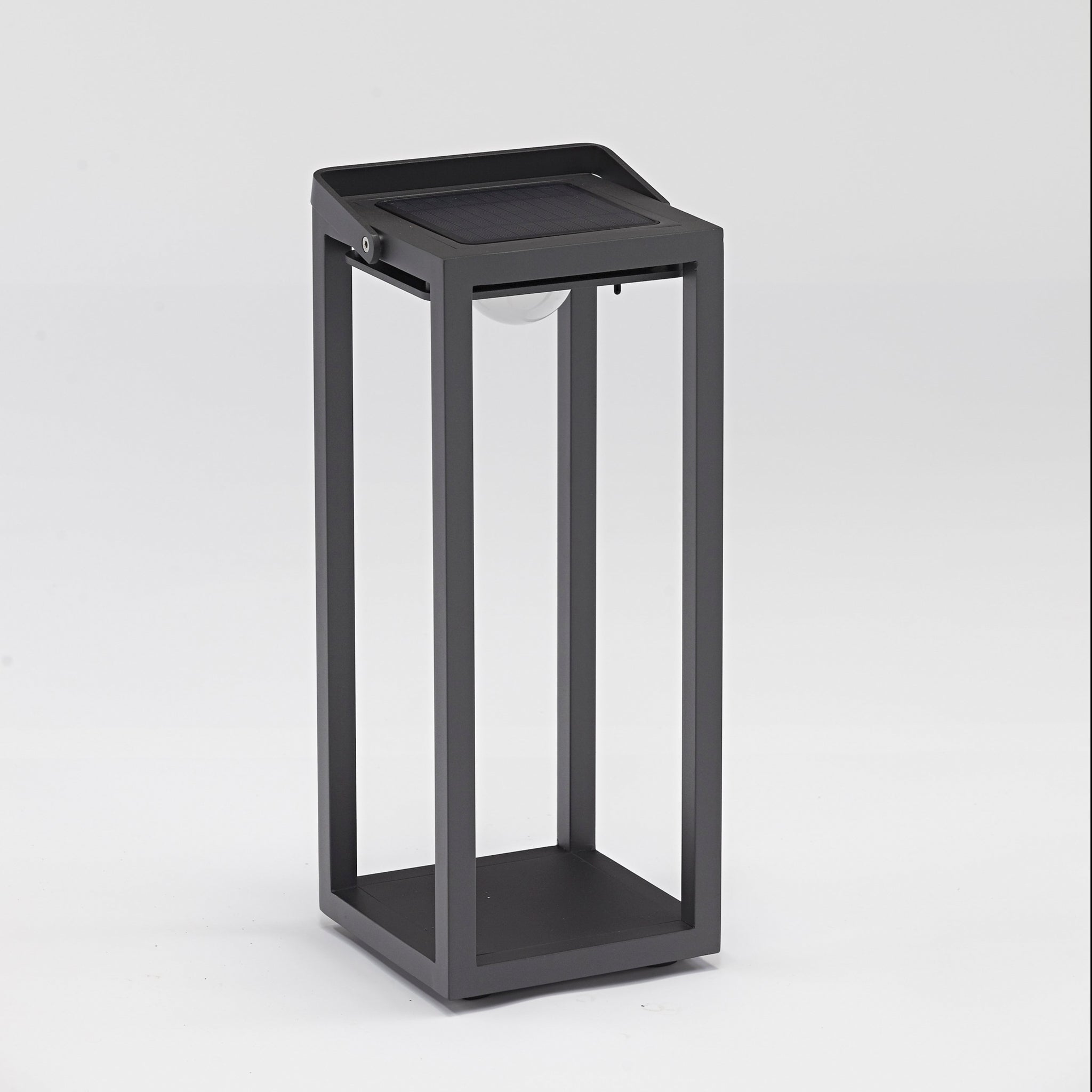 The Luxor Large Floor Outdoor and Indoor Solar Lantern in Charcoal is a modern, rectangular light with a solar panel on top and a bulb in the center, designed in a minimalist style. This weatherproof lantern features an automatic switch for effortless convenience.