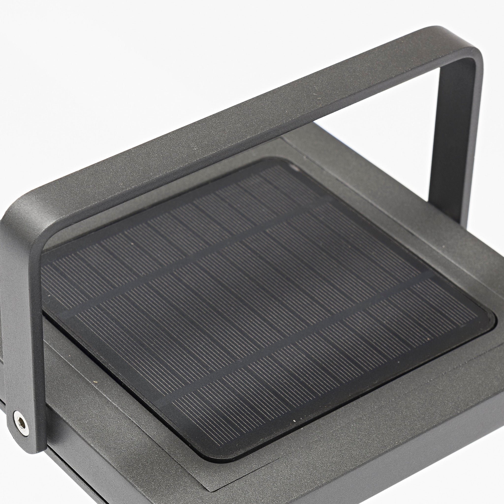 A close-up of the Luxor Large Floor Outdoor and Indoor Solar Lantern in Charcoal showcases its sleek, flat solar panel with a rectangular frame, complete with an automatic switch on top.