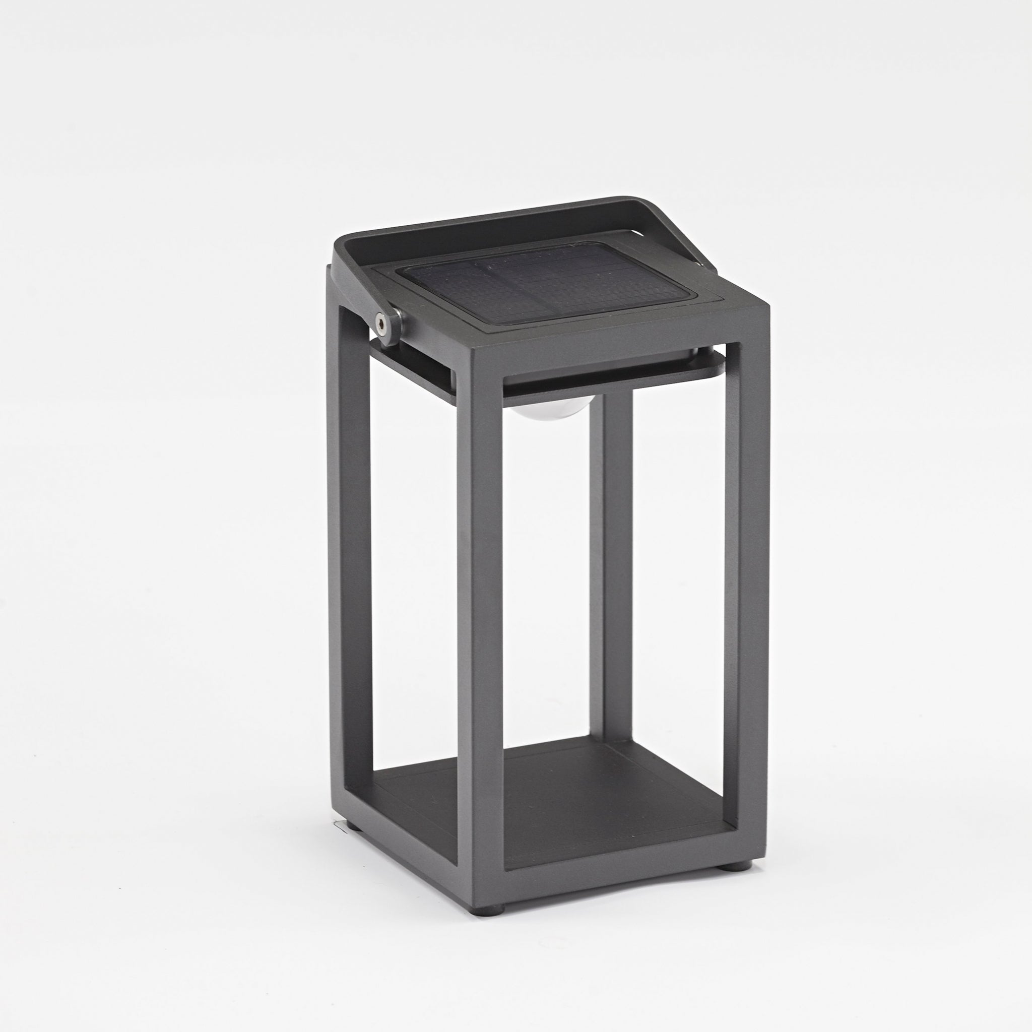 The Luxor Small Table Outdoor and Indoor Solar Lantern in Charcoal features a rectangular frame with an open design and a solar panel on top, providing sustainable lighting in any weather.