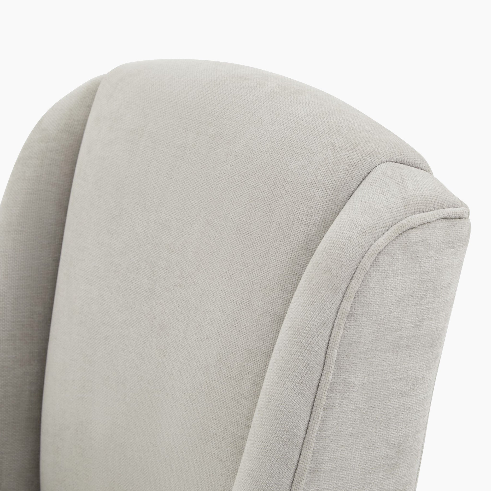 Close-up of the Kingham Grey Dining Chair back featuring a light gray woven fabric with subtle textured upholstery.