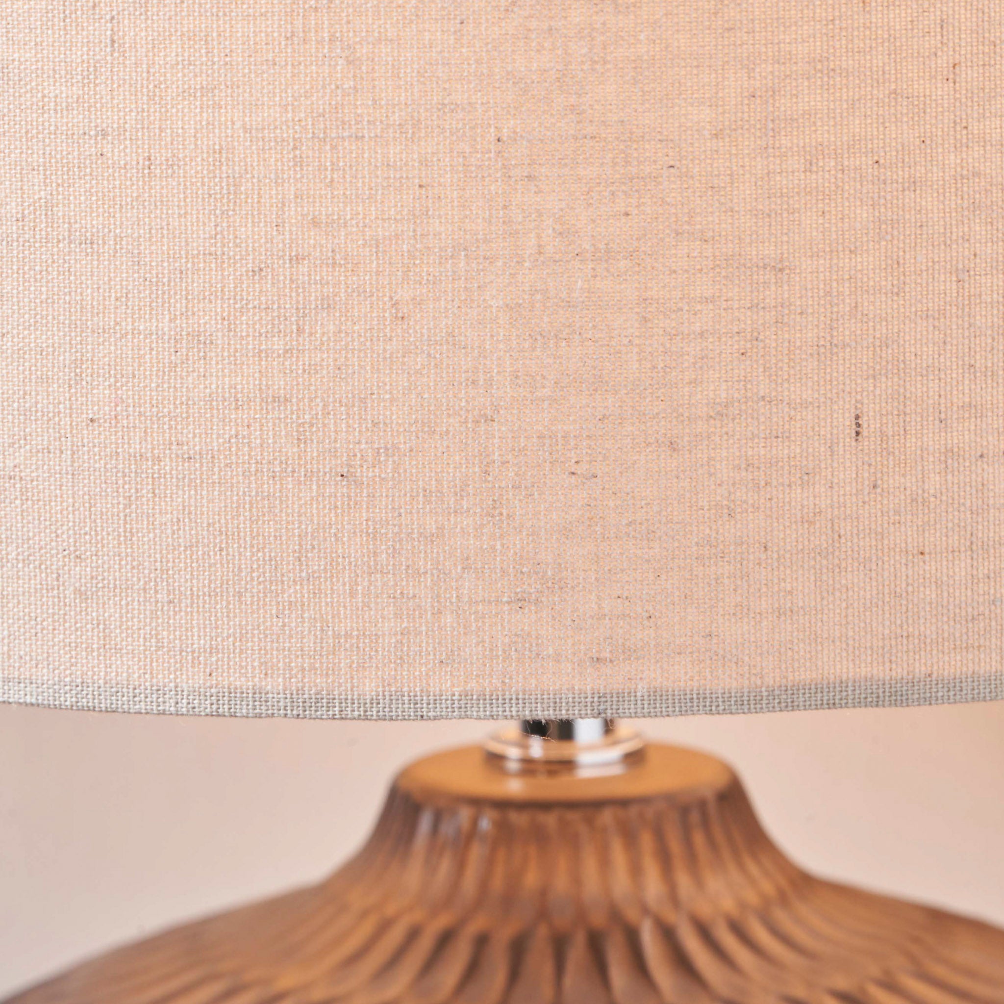 Close-up of the Cassius Bronze Textured Glazed Ceramic Table Lamp with a linen-look shade and a durable textured brown ceramic base.