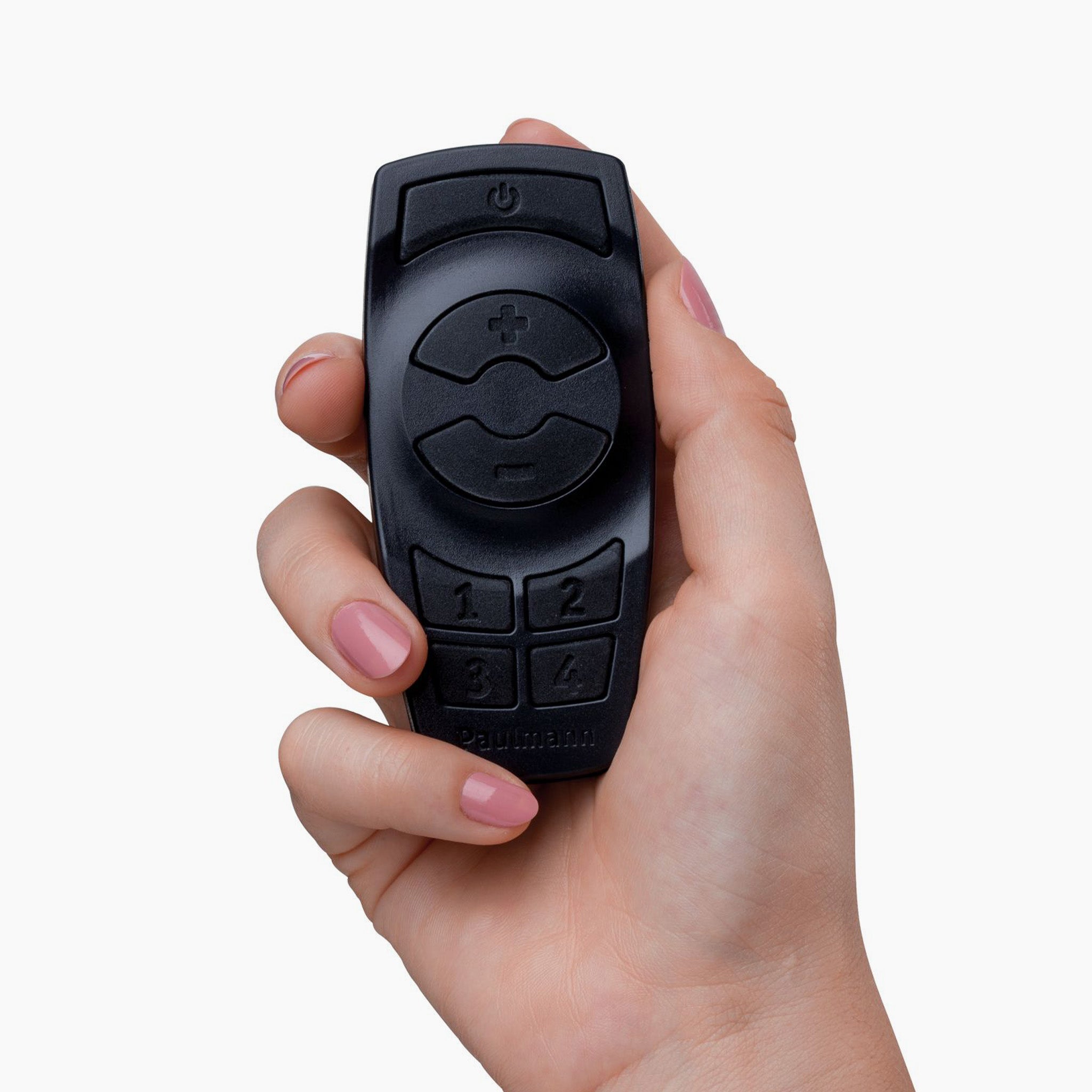 Close-up of a hand holding a black Paulmann Plug & Shine Outdoor Wireless Controller with Remote, featuring several buttons and a circular directional pad, ideal for effortlessly managing outdoor lighting.