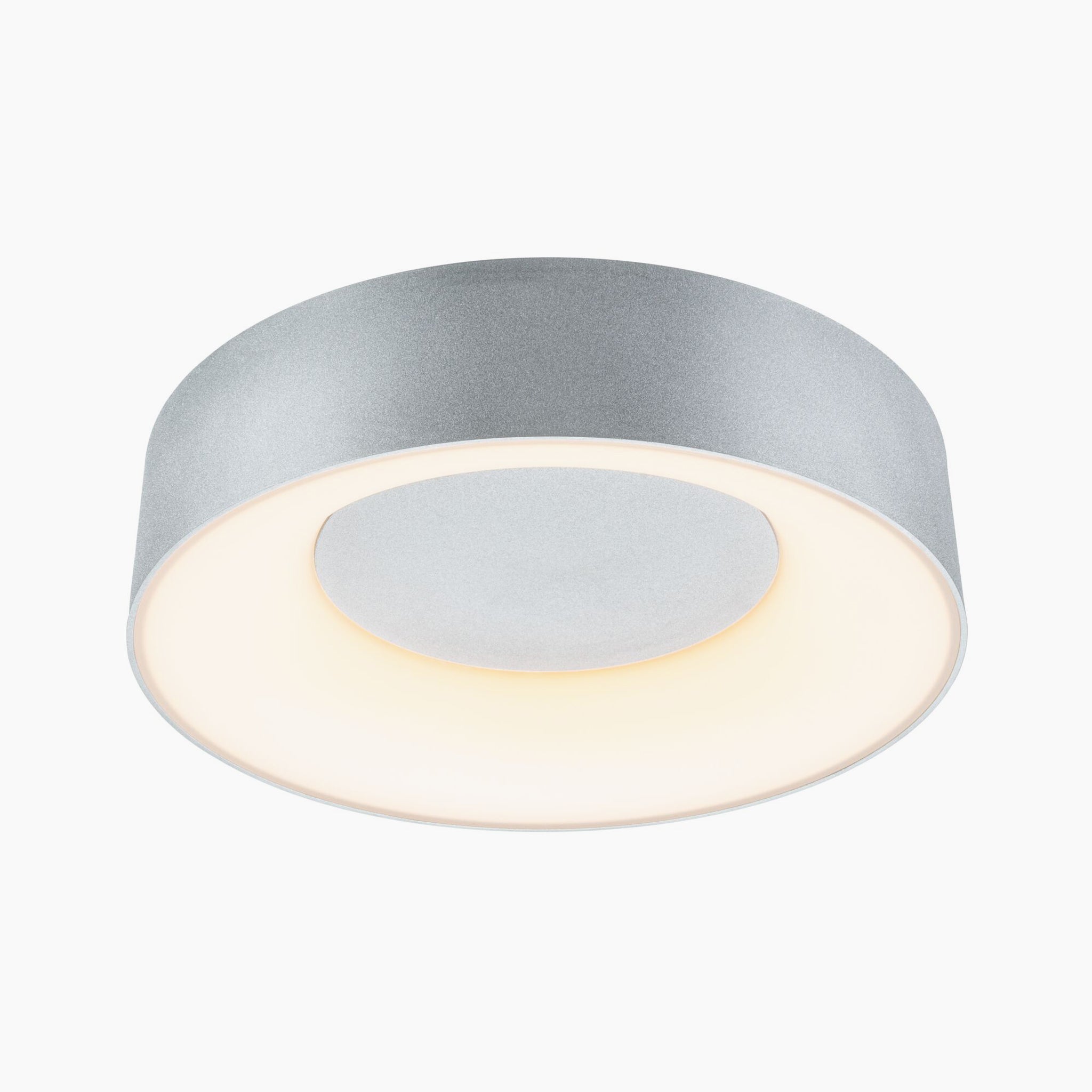 The Casca 18W LED Switch Ceiling Light in Matt Aluminium is a modern, round fixture with a sleek gray exterior that emits a glowing white light. With its 1500 lumens, it creates special lighting effects and allows you to adjust the light color to match any mood.