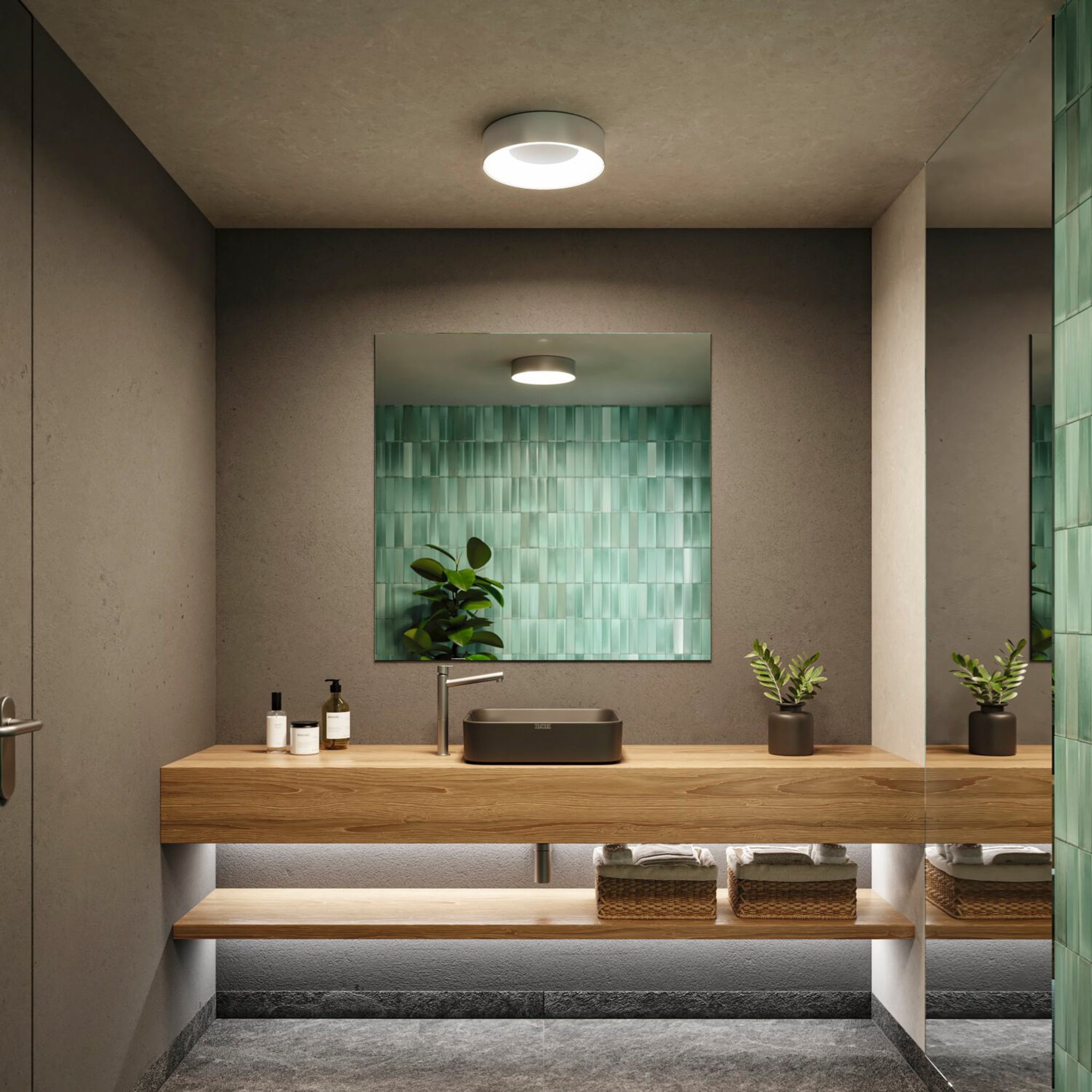 Modern bathroom with a wooden vanity, green tiles behind the mirror, potted plants, and under-shelf wicker baskets. Special lighting effects create an inviting ambiance, while a Casca 18W LED Switch 1500lm Ceiling Light in Matt Aluminium allows you to adjust the light color to suit your mood.