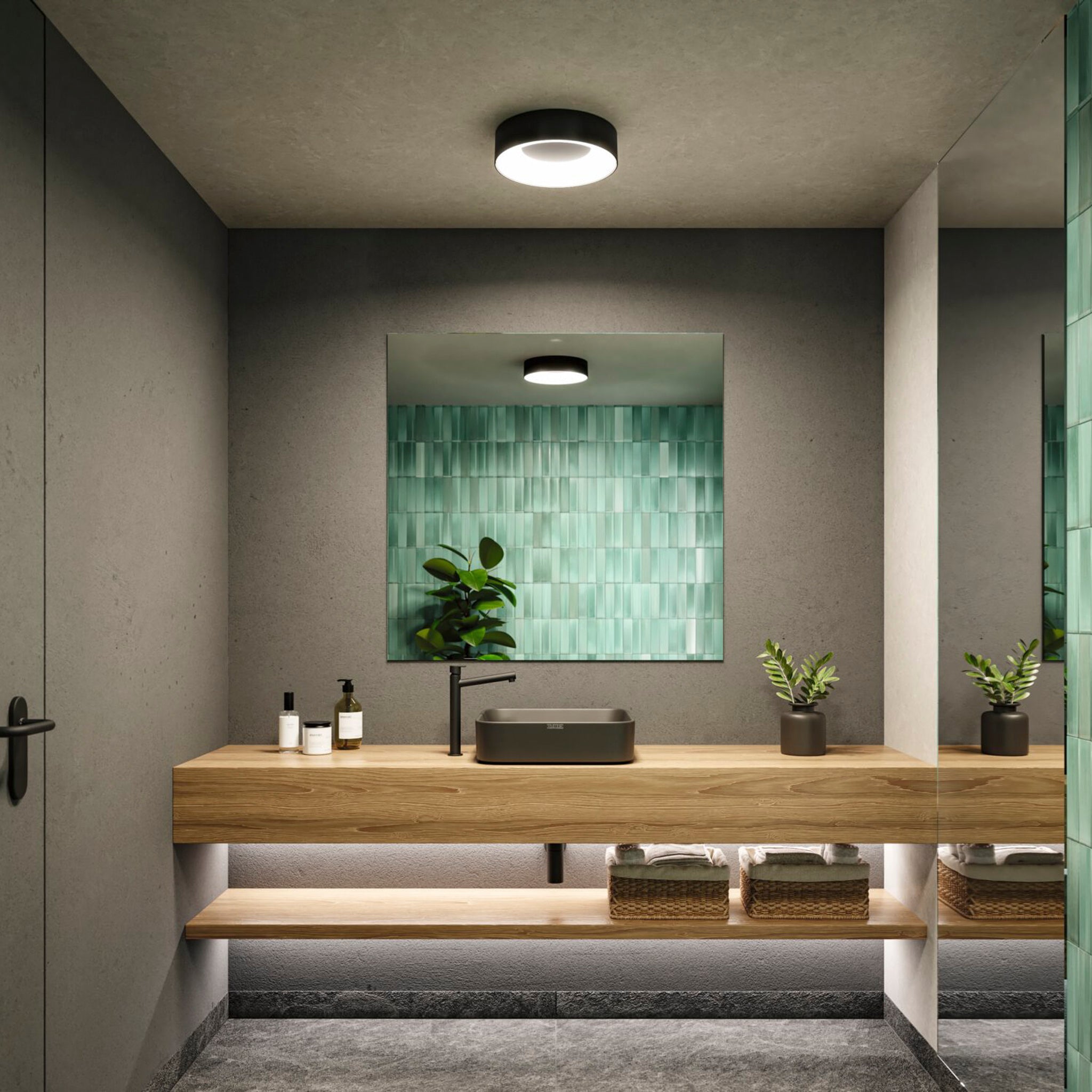 Modern bathroom with wooden vanity, two plants, and green tiled backsplash. Large mirror reflecting the special lighting effect of the Casca 18W LED Switch 1500lm Ceiling Light in Black Matt.