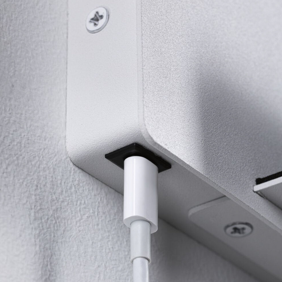 Close-up of a white cable plugged into the Halina 3.5W LED Wall Light with USB Charging Port in White Matt, featuring a flexible arm and visible screws.