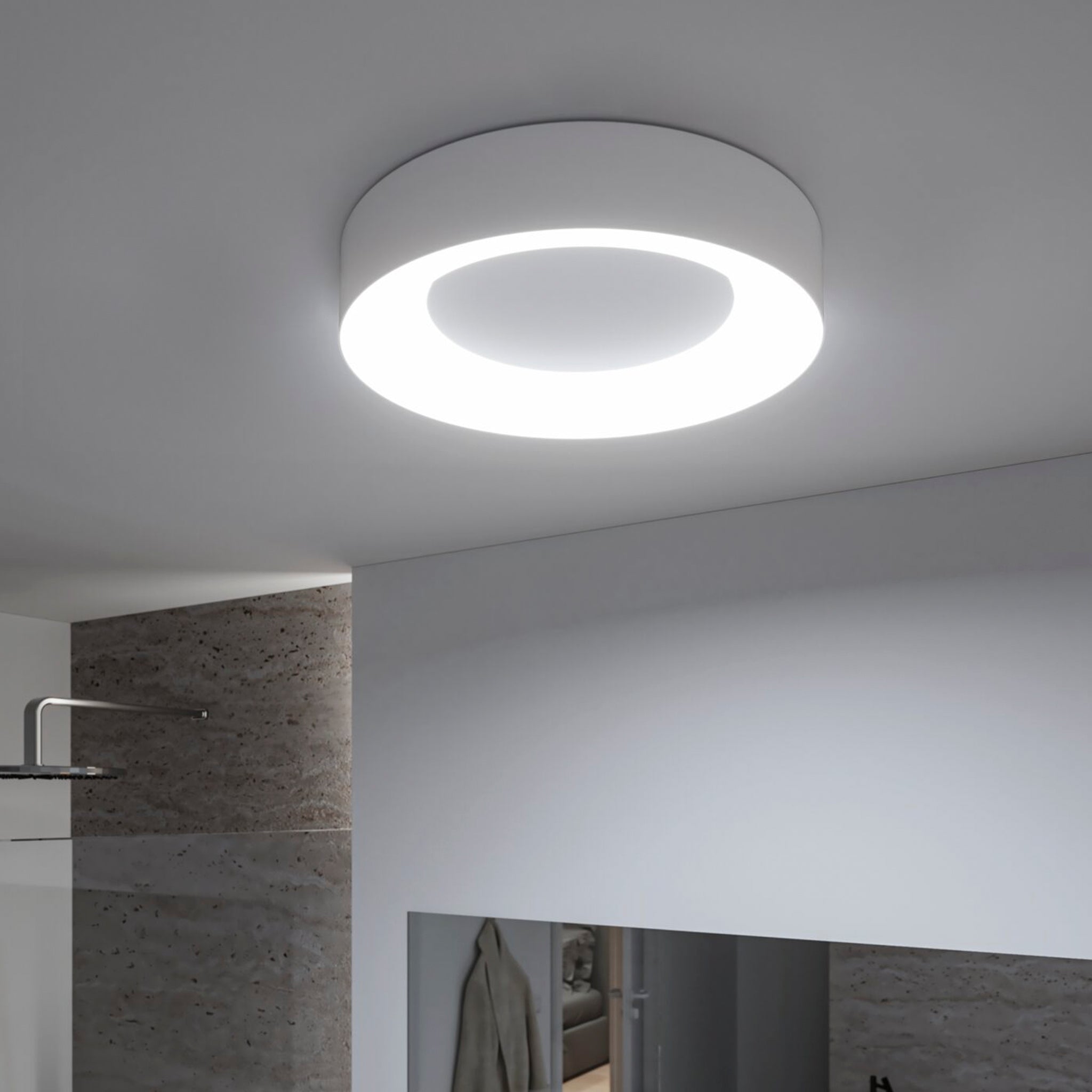 The Casca 25W LED Switch 2100lm Ceiling Light in White features a modern circular design with a glowing ring, perfect for illuminating a minimalistic, contemporary room while offering adjustable light color for a customized lighting effect.