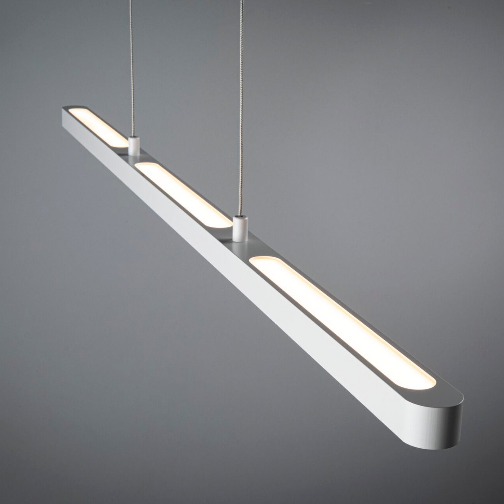 Sleek and modern, the Paulmann Lento 37W LED dimmable pendant light in white features an elongated design that offers soft, adjustable illumination against a plain gray background.