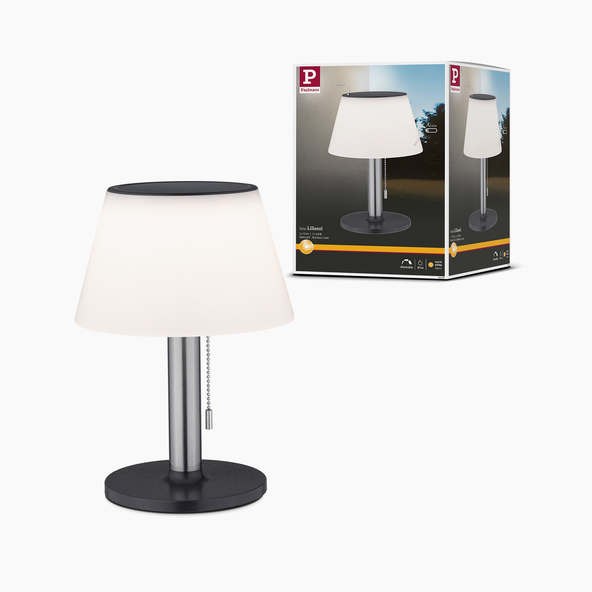 The Outdoor Lillesol 0.8W LED Solar Table Lamp with 3-Step Dim in Stainless Steel, featuring a small black and silver design and a white lampshade, sits elegantly next to its packaging box, making it perfect for garden lighting.