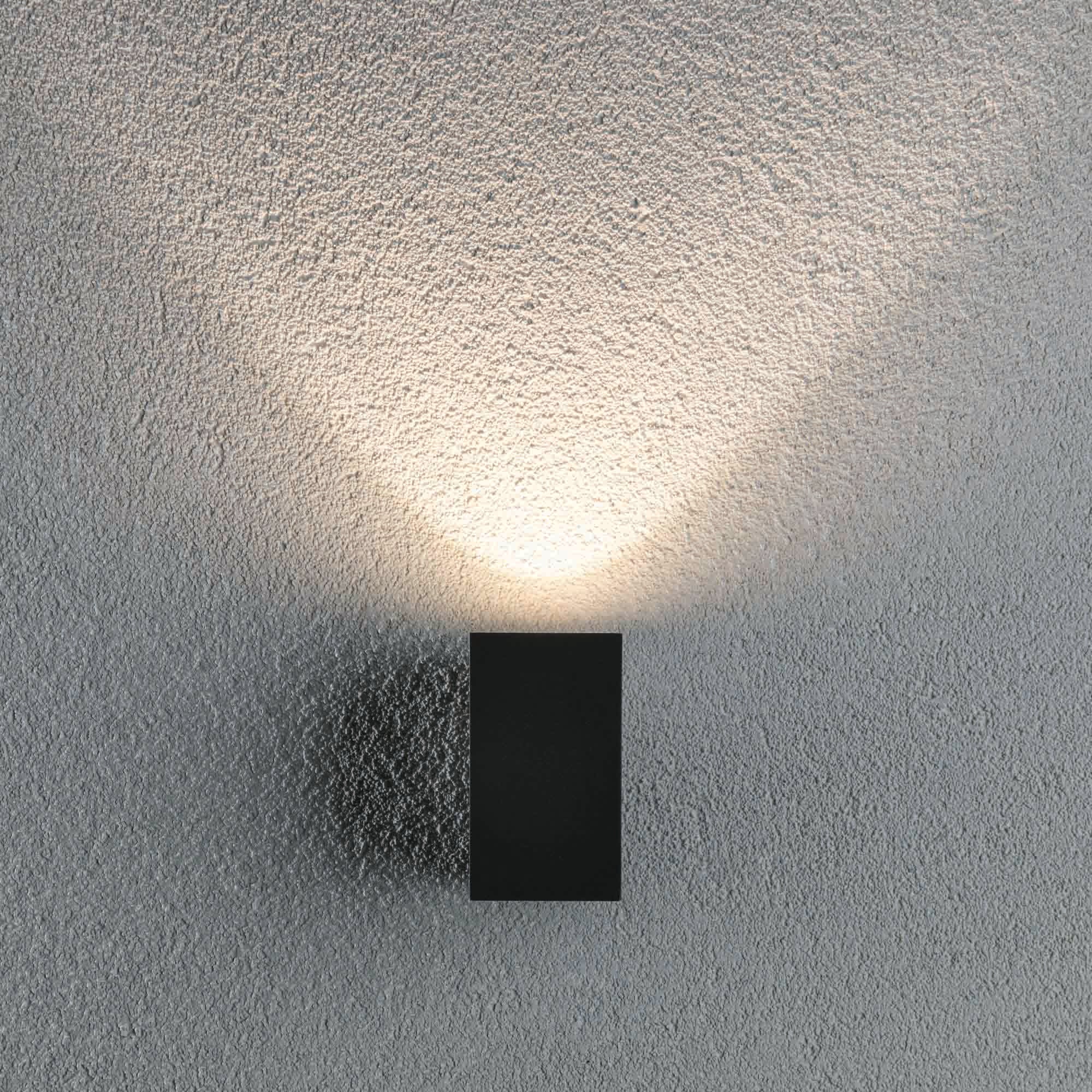 The Paulmann Outdoor Flame 5.2W LED Single Output Wall Light in Anthracite casts a soft glow with advanced LED technology, beautifully highlighting the textured surface.