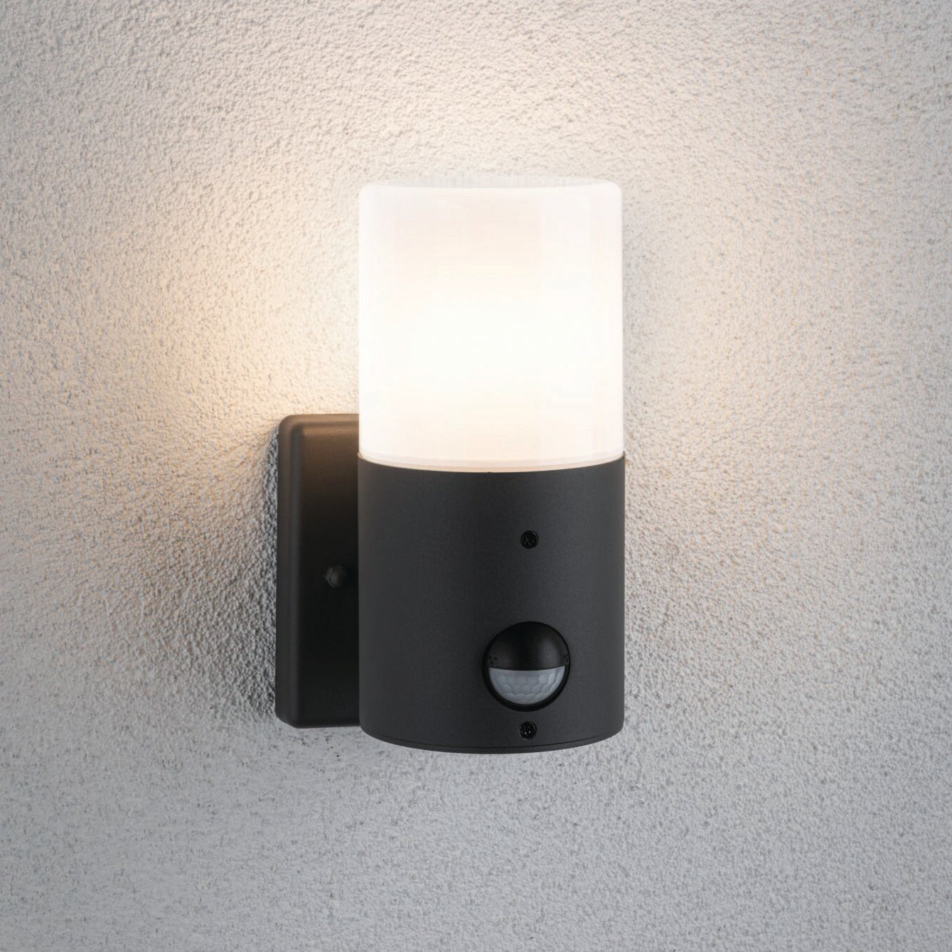 The Paulmann Outdoor Tubs 15W LED Wall Light with Motion Detection in Grey Matt is a contemporary exterior wall luminaire featuring a frosted glass shade, elegantly mounted on a light-colored textured wall.