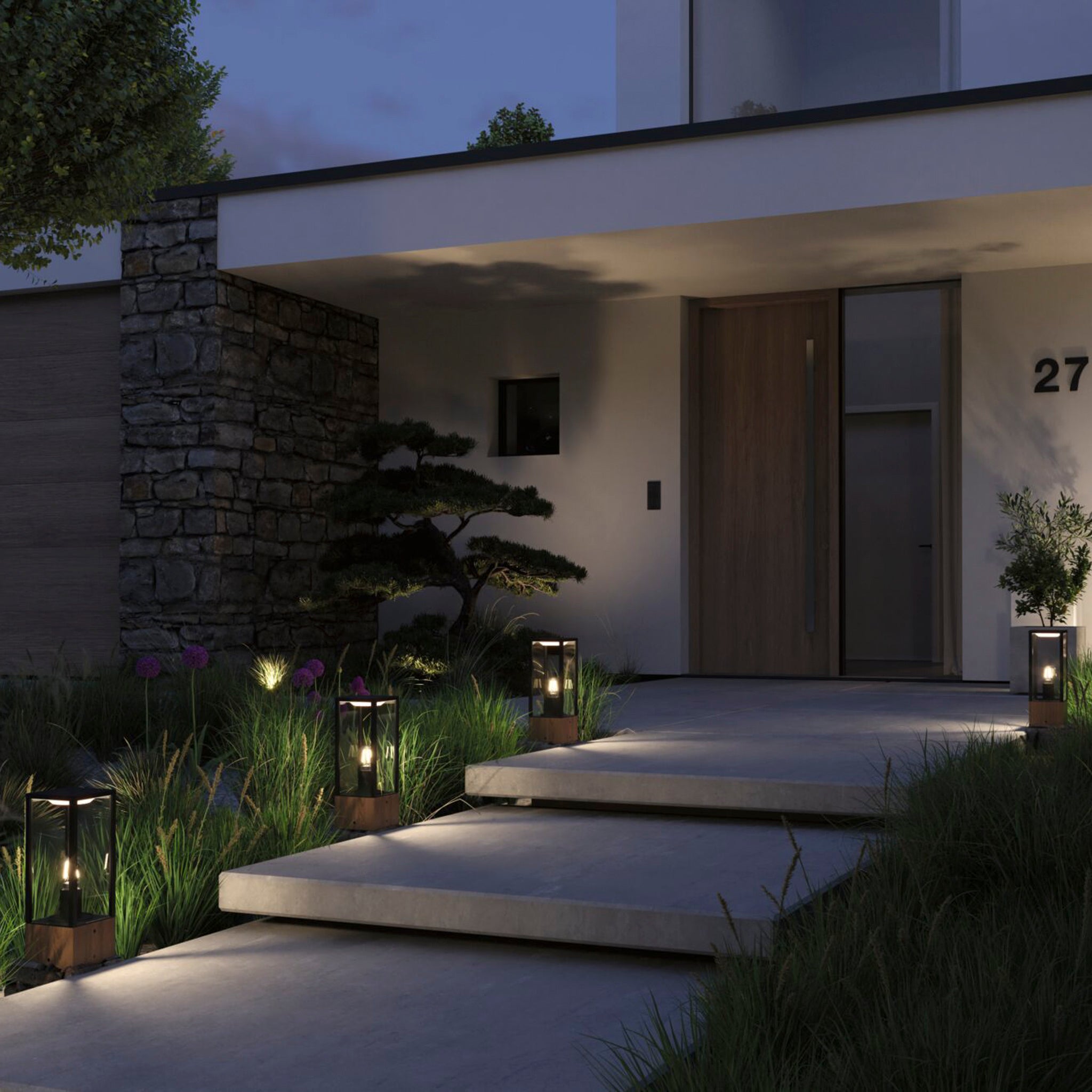 The entrance of the modern house is adorned with atmospheric lighting from the Paulmann Plug & Shine Outdoor Vena 2W LED 40cm Wooden Single Bollard Light, illuminating the pathway and showcasing a stone wall with minimalist plants and house number 27, creating an inviting ambiance at night.