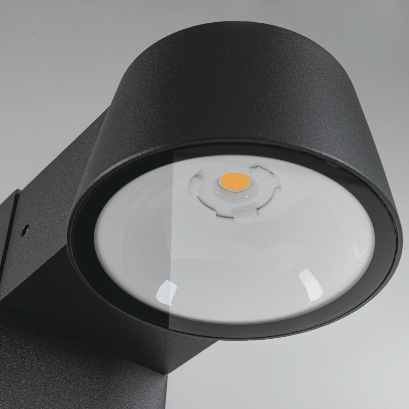 Close-up of the Outdoor Capea 8W LED Bollard Light in anthracite, featuring a modern black design with a circular lens and an insect-friendly yellow LED in the center, perfect for outdoor lighting.