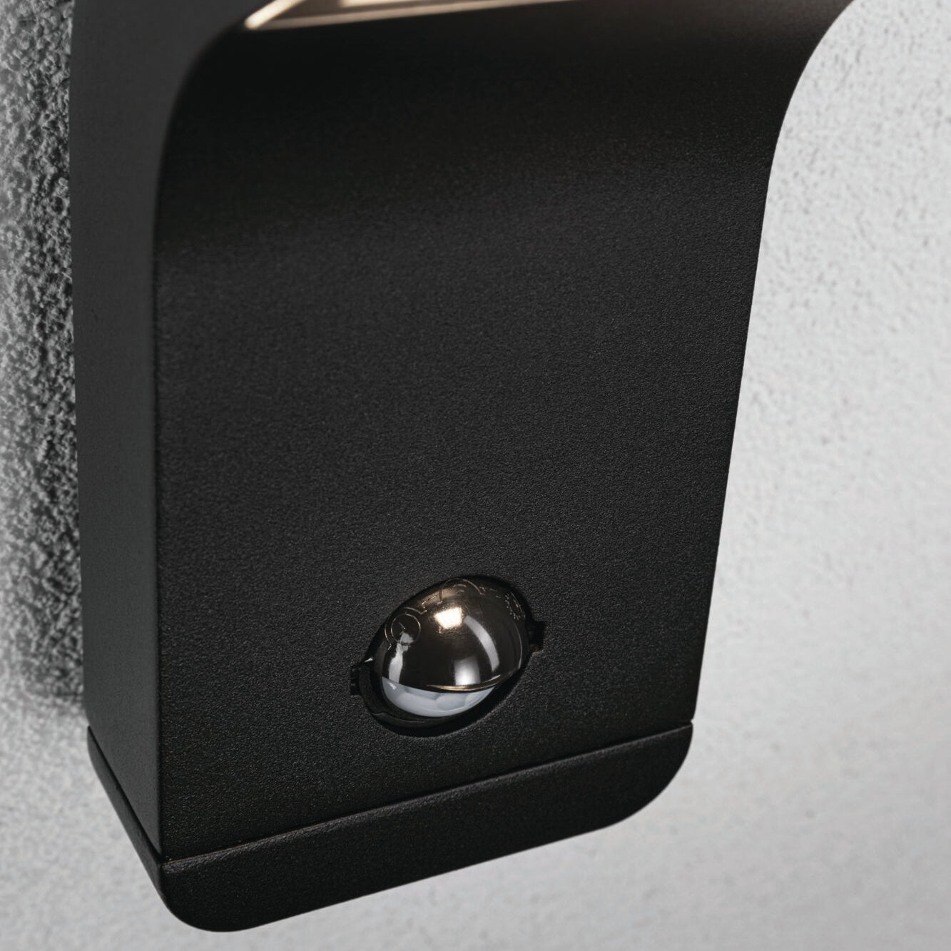 Close-up of an Outdoor Kulma 9W LED Wall Light with Motion Detection in Anthracite, featuring a small reflective sensor in the center.