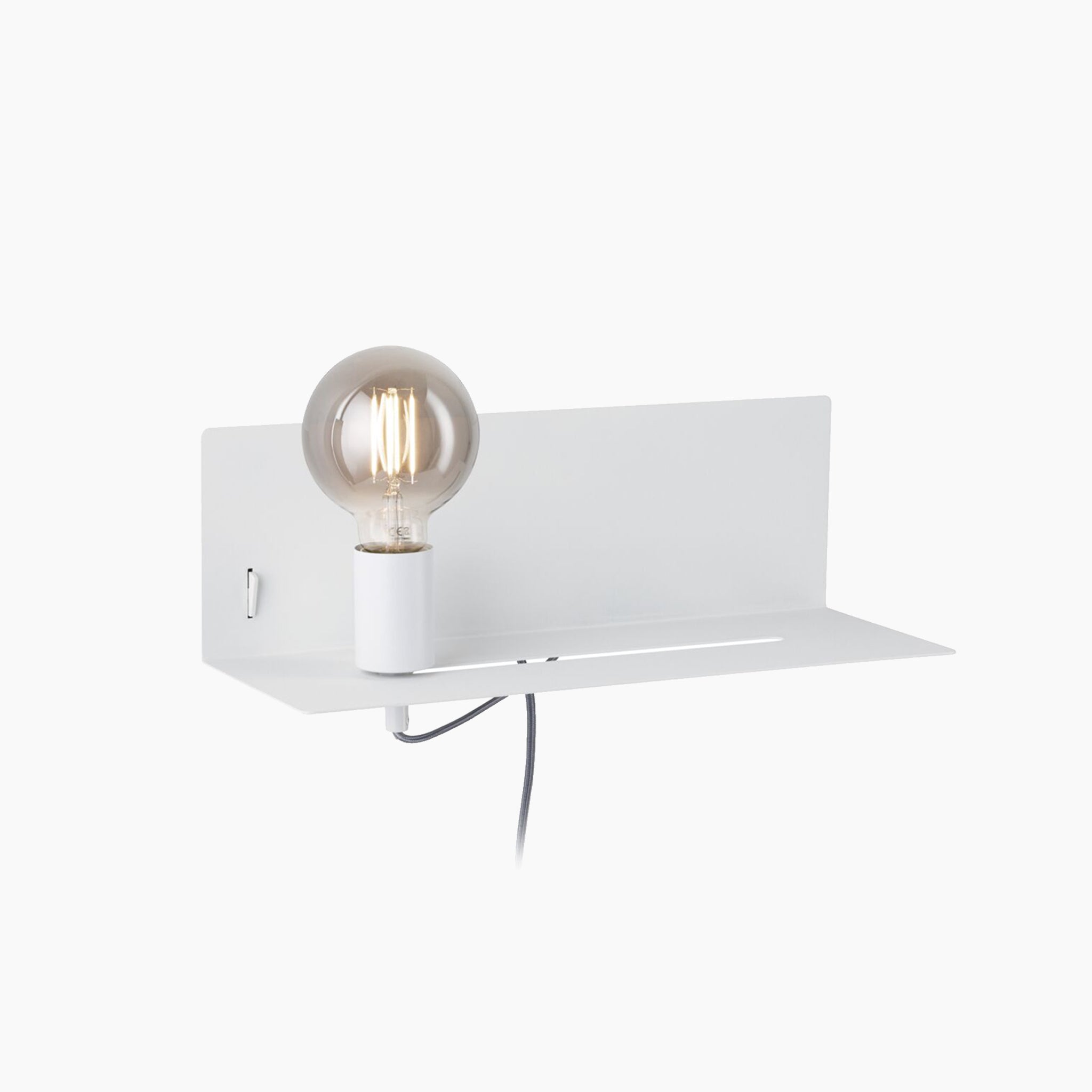 The Devara 40W Wall Mounted Lamp with USB Port in White Matt is a minimalistic wall-mounted reading luminaire that features an exposed bulb on a sleek white metal integrated shelf.