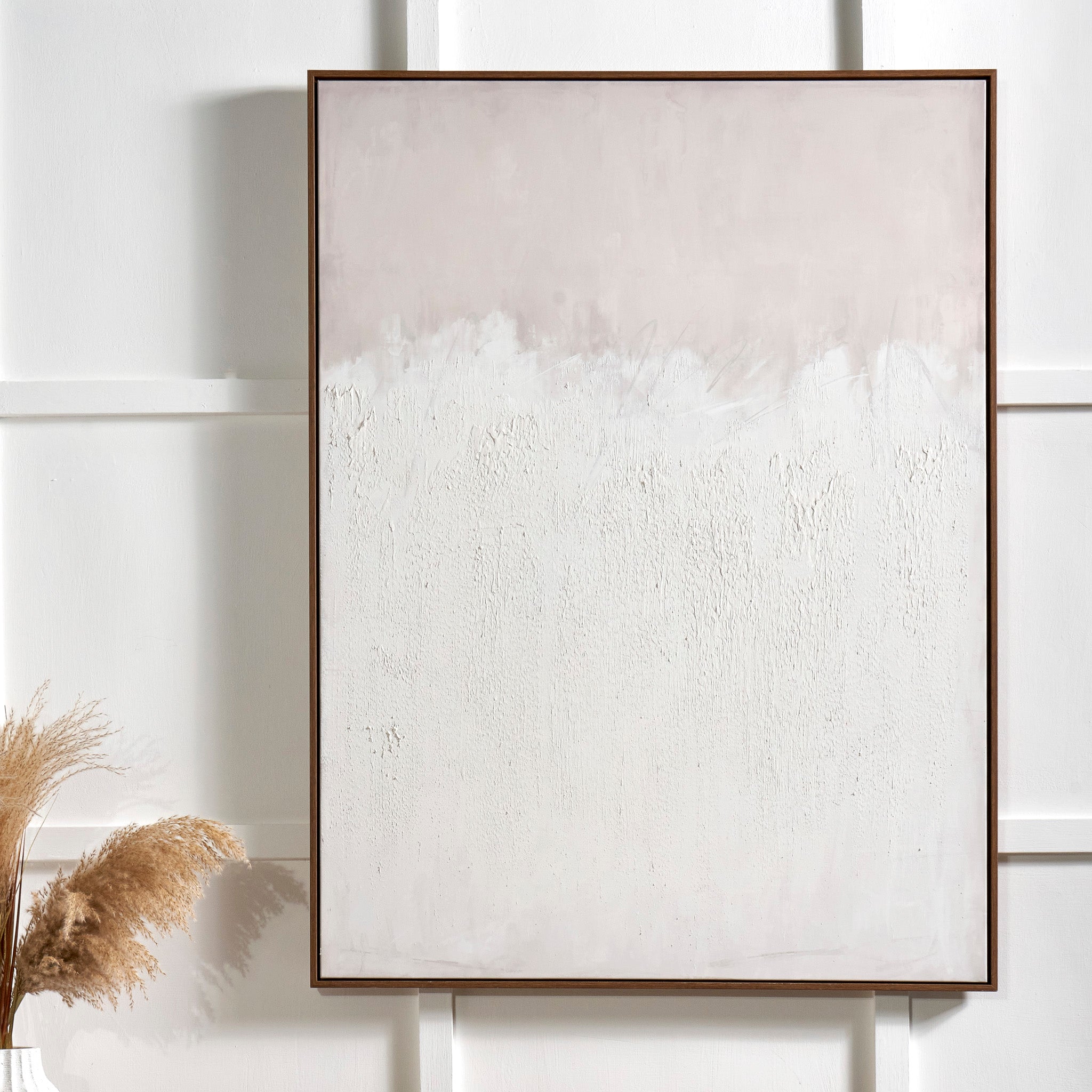 The Natural and White Abstract Canvas with Natural Frame Large features textured white and beige tones, providing a minimalist elegance that effortlessly complements various interior styles.