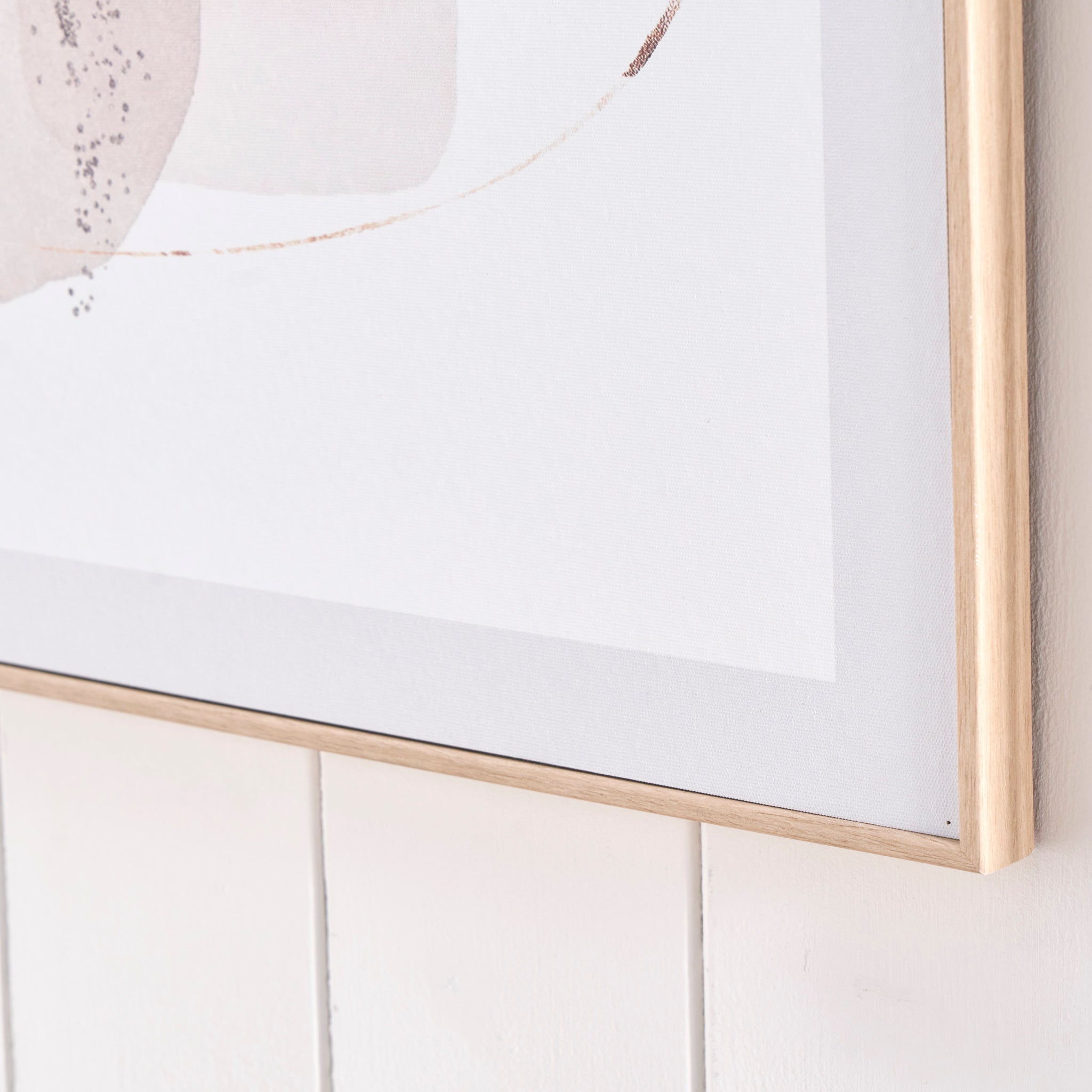 A close-up of the "Natural Abstract Canvases with Natural Frame," showcasing an abstract design set against a white wooden wall, enclosed in a natural wood veneer frame.