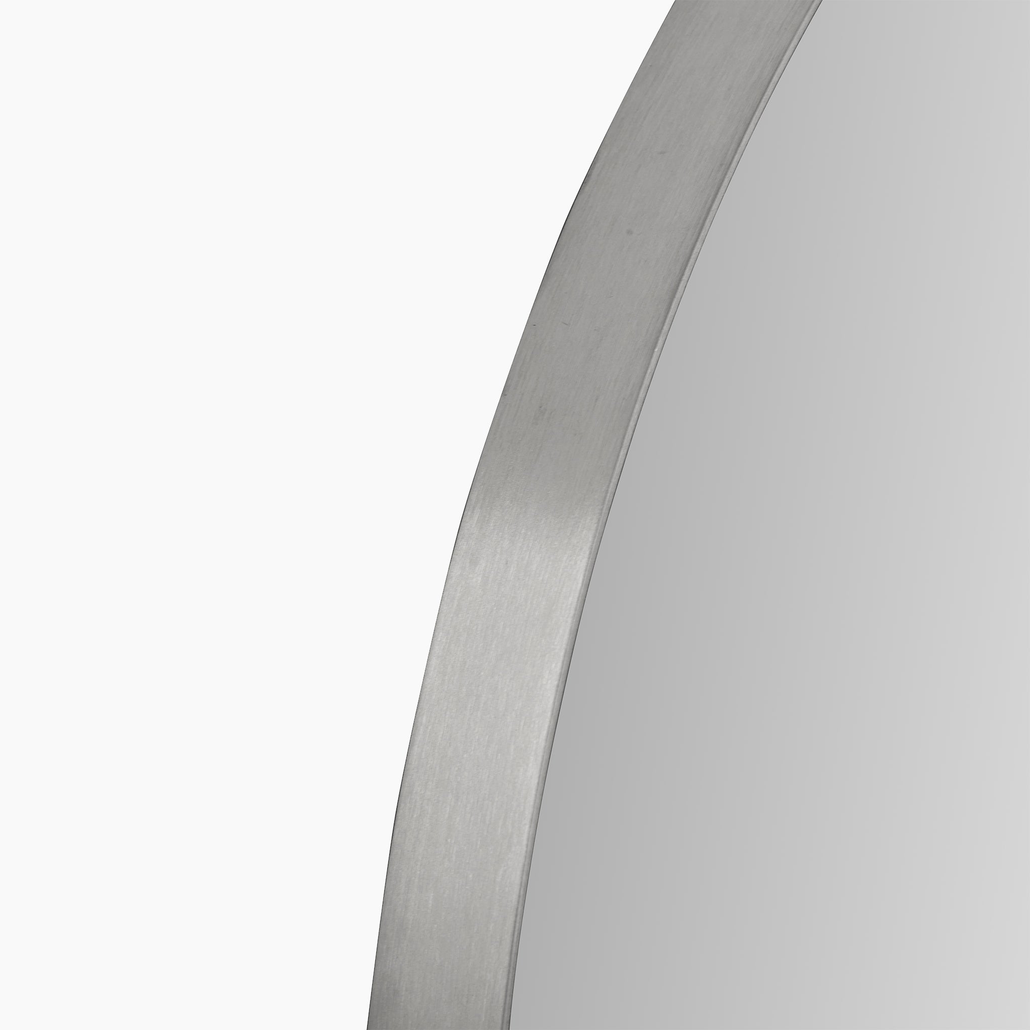 Close-up of a round wall mirror with a sleek, slim metal frame finished in brushed silver, set against a crisp white background.