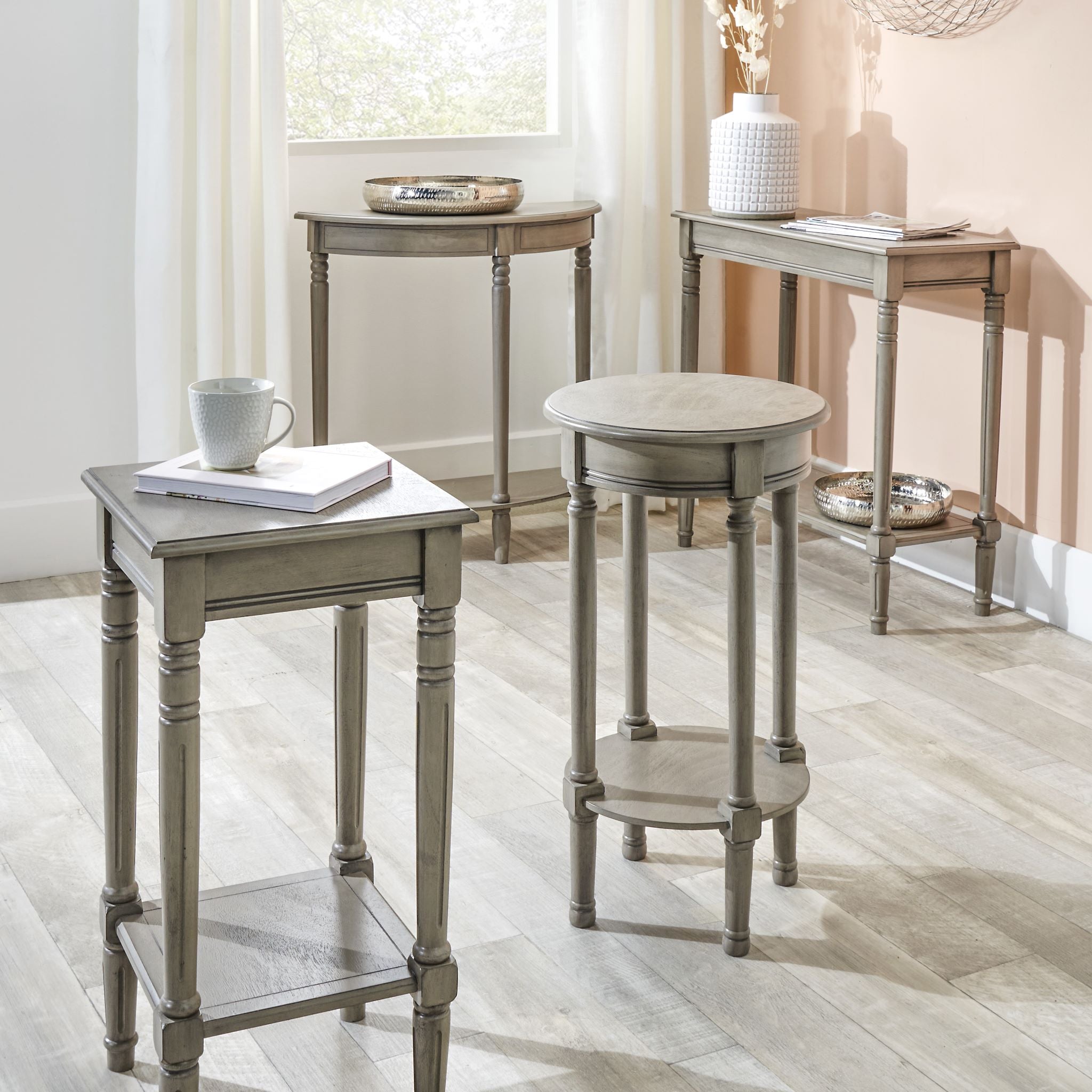 A set of four Heritage Taupe Pine Wood Rectangular Consoles from the Ashwell collection graces a bright room with light-colored wooden flooring, adding a touch of elegance with their taupe finish pine wood.