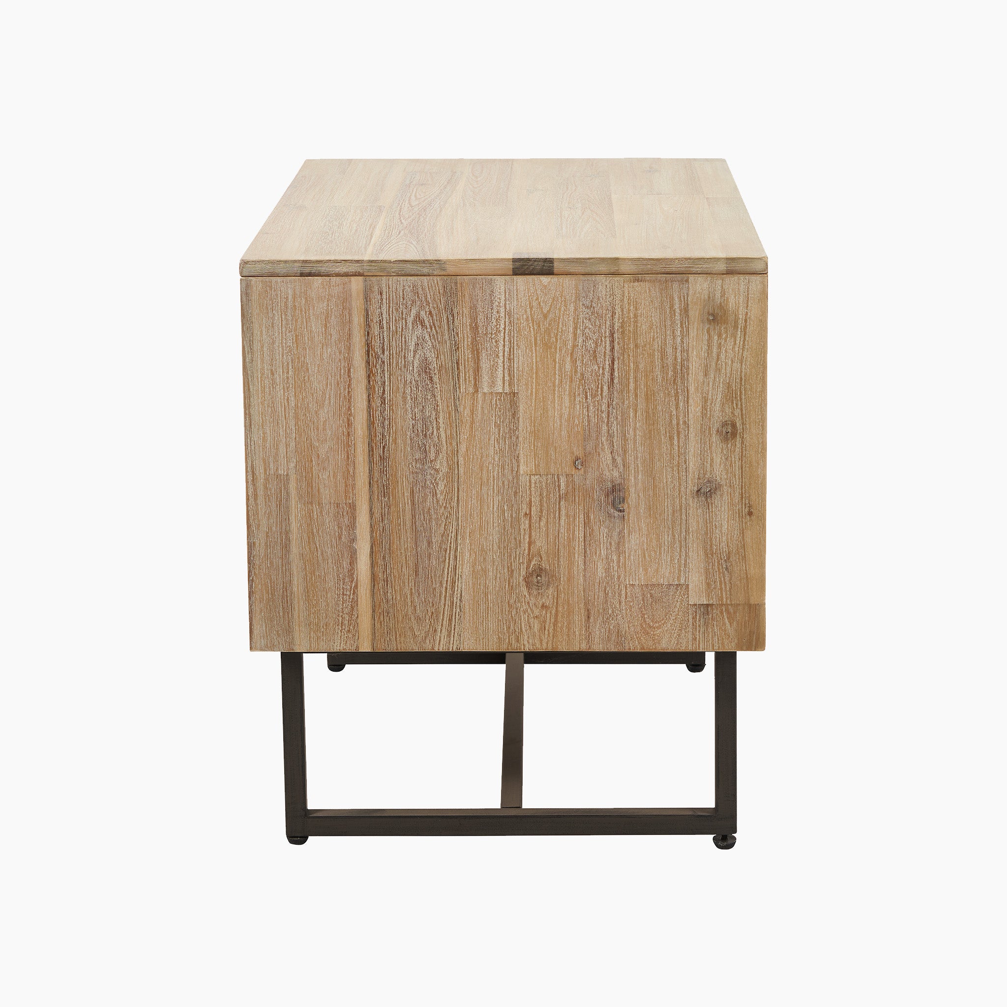 A side view of the Marca Sand Wash Acacia Wood and Black Metal Bedside Unit, showcasing its rectangular shape, weathered acacia wood finish, and black metal legs, perfect for a Scandi-style bedroom.