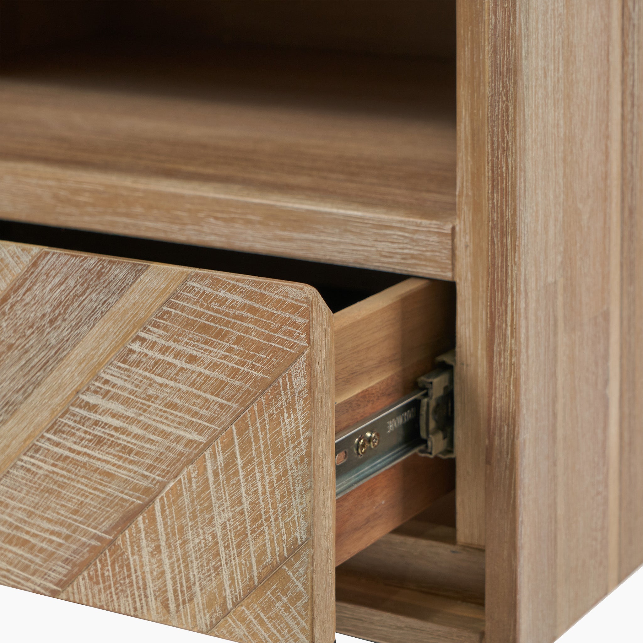 Close-up of the Marca Sand Wash Acacia Wood and Black Metal Bedside Unit with a partially open drawer, showcasing the textured front and metal sliding mechanism, providing ample storage space.