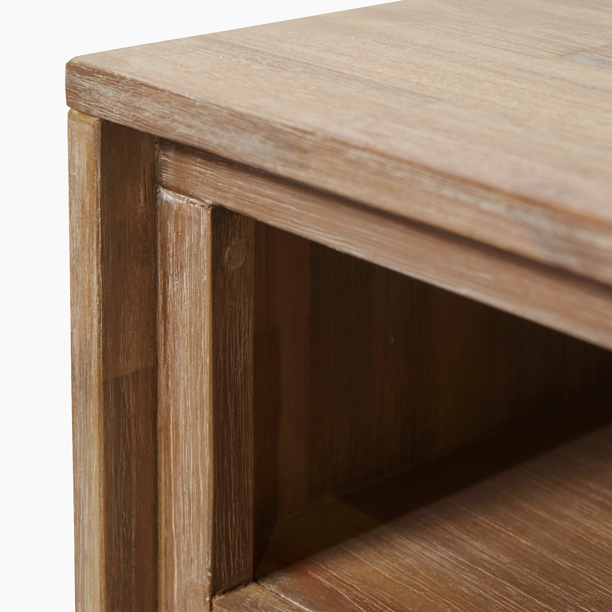 Close-up of a Marca Sand Wash Acacia Wood and Black Metal Bedside Unit corner, showcasing the surface texture and ample storage space below.