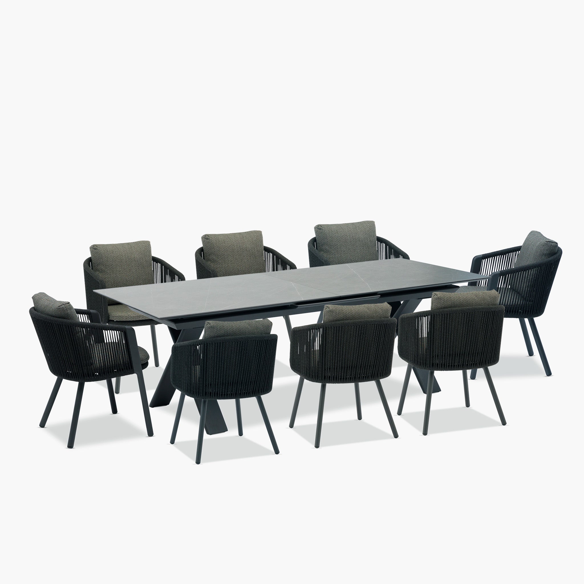 Upgrade your outdoor area with the Dekota 8 Seat Rope Extending Dining Set in Charcoal. It includes a rectangular table and eight ergonomically designed chairs with dark frames and gray cushions, ideal for any occasion.