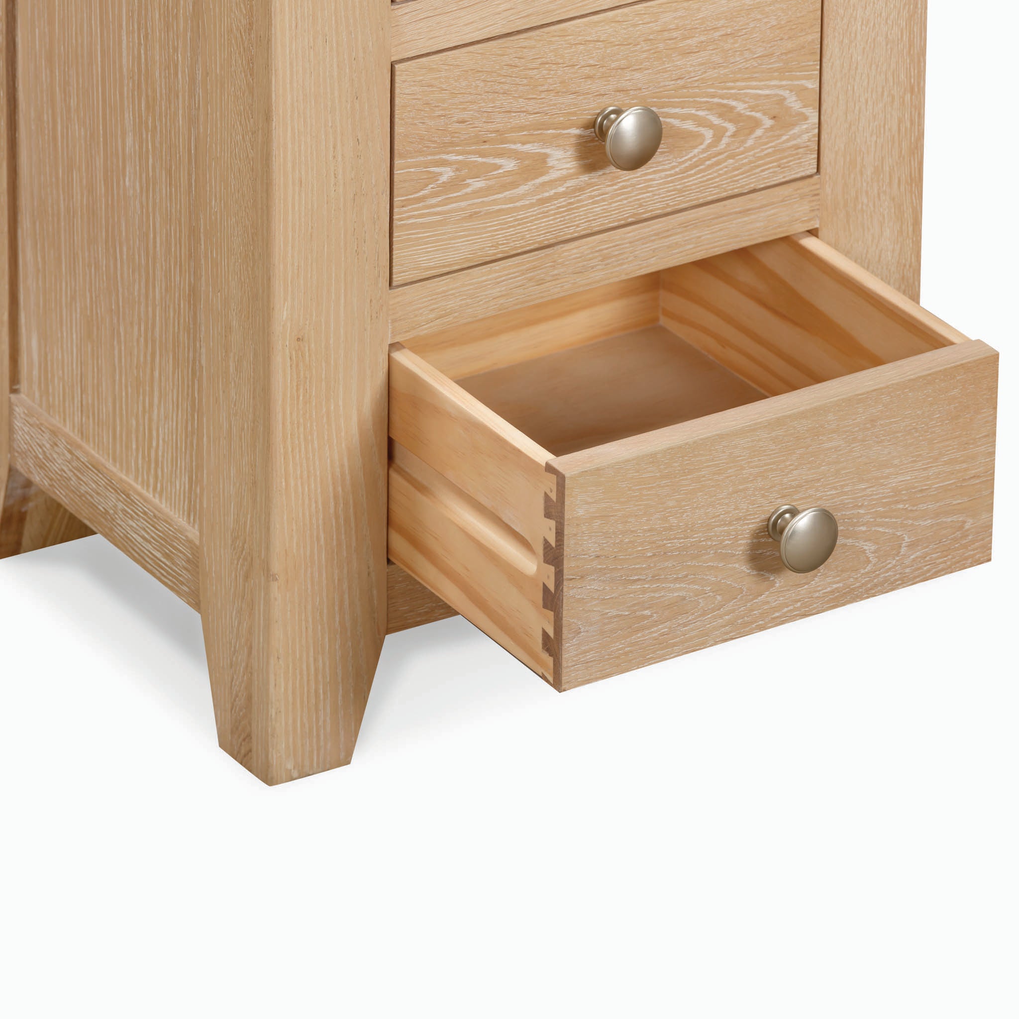 The Burford 3 Drawers Bedside Table in Natural Oak, featuring metallic knobs and a finely crafted wooden exterior, perfectly complements your existing natural oak furniture while providing ample storage with its spacious drawers.