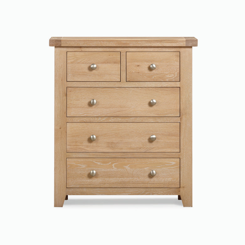 The Burford range offers a 2 Over 3 Chest of Drawers in Natural Oak, featuring five drawers, including three spacious ones at the bottom and two smaller ones on top, providing ample storage solutions.