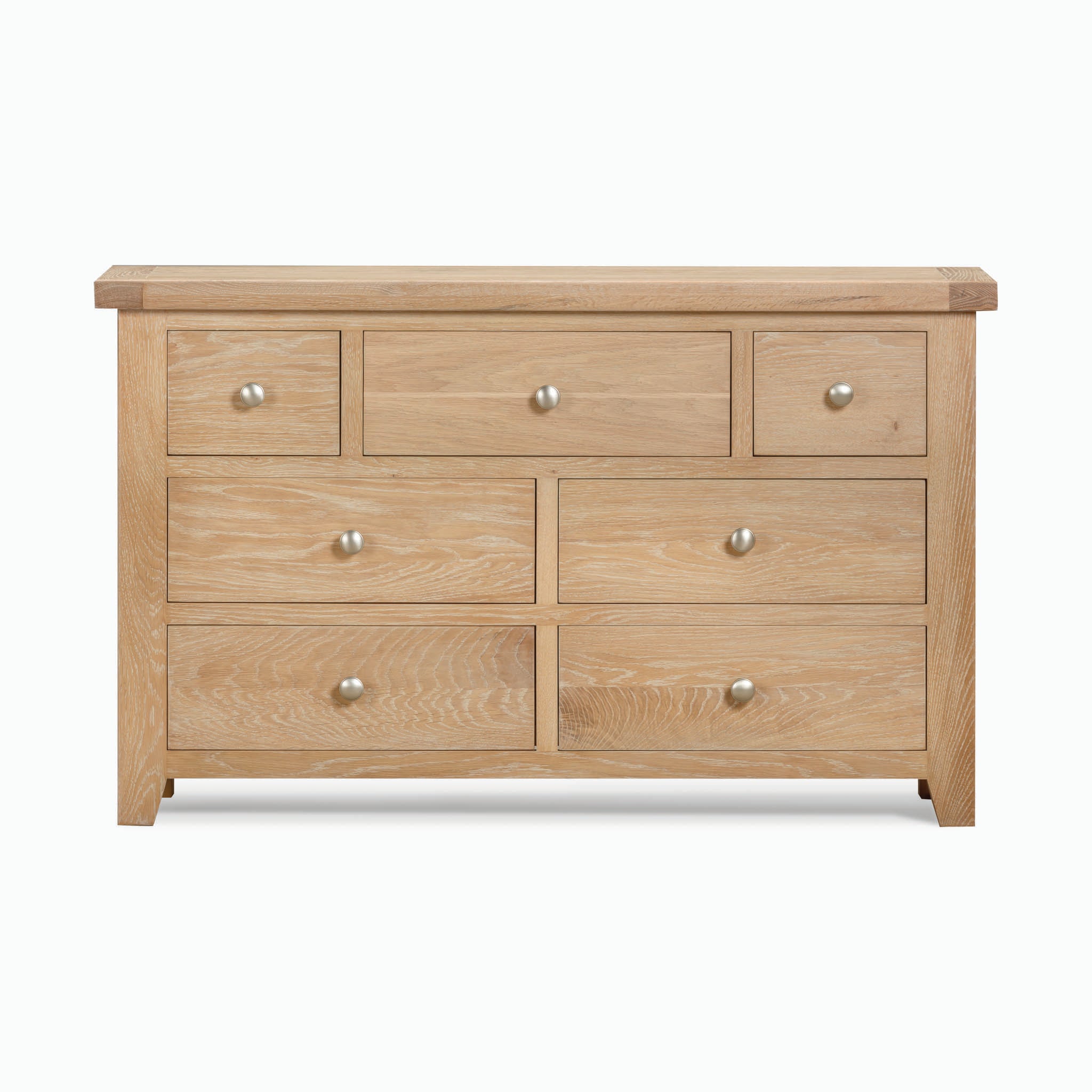 The Burford 3 Over 4 Chest of Drawers in Natural Oak showcases a rustic aesthetic, featuring seven drawers—three smaller ones on top and four larger ones below—each adorned with round metal knobs. This wooden dresser is perfect for adding charm to any room.