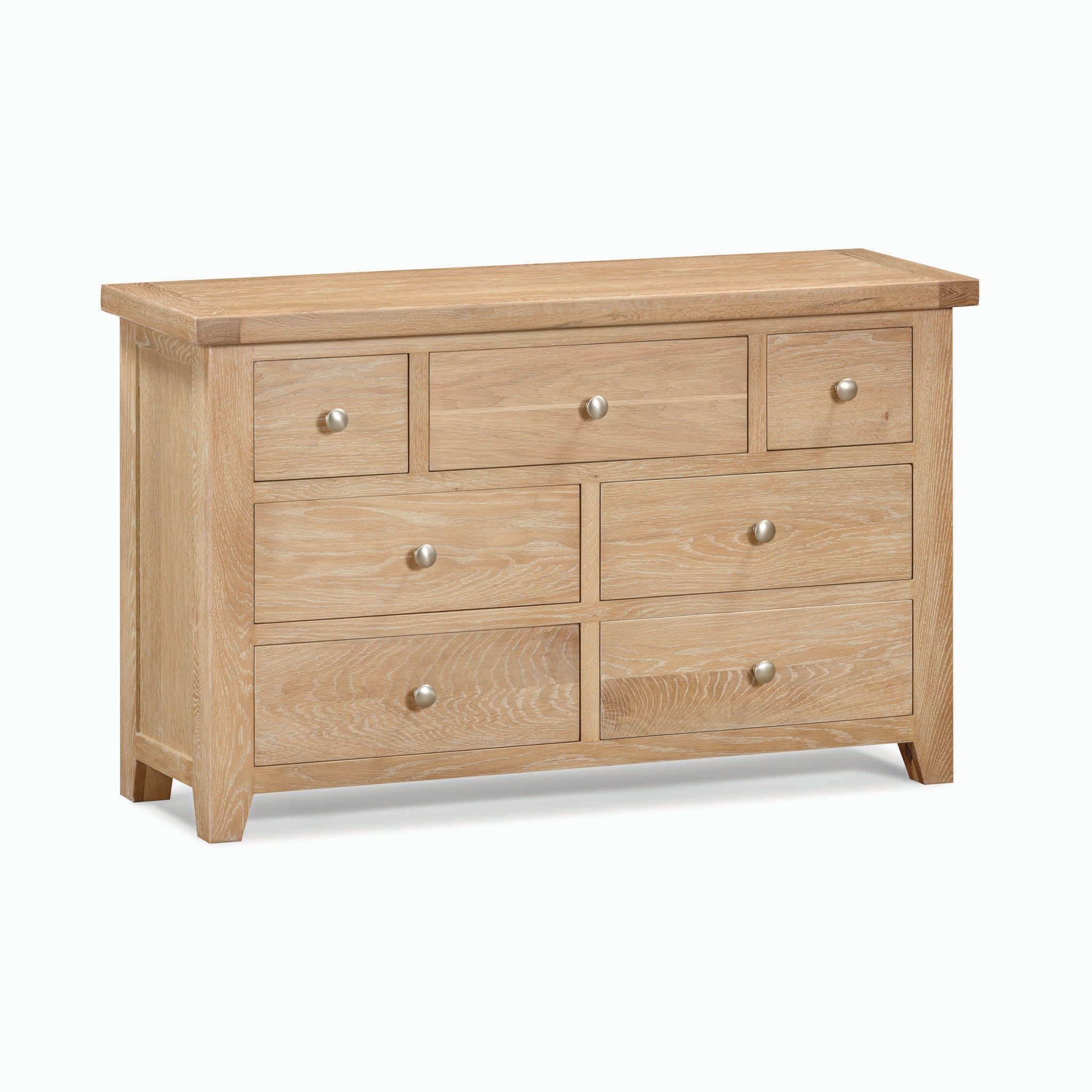 The Burford 3 Over 4 Chest of Drawers in Natural Oak features seven drawers in a simple, natural finish, offering a perfect blend of rustic aesthetic and functionality.