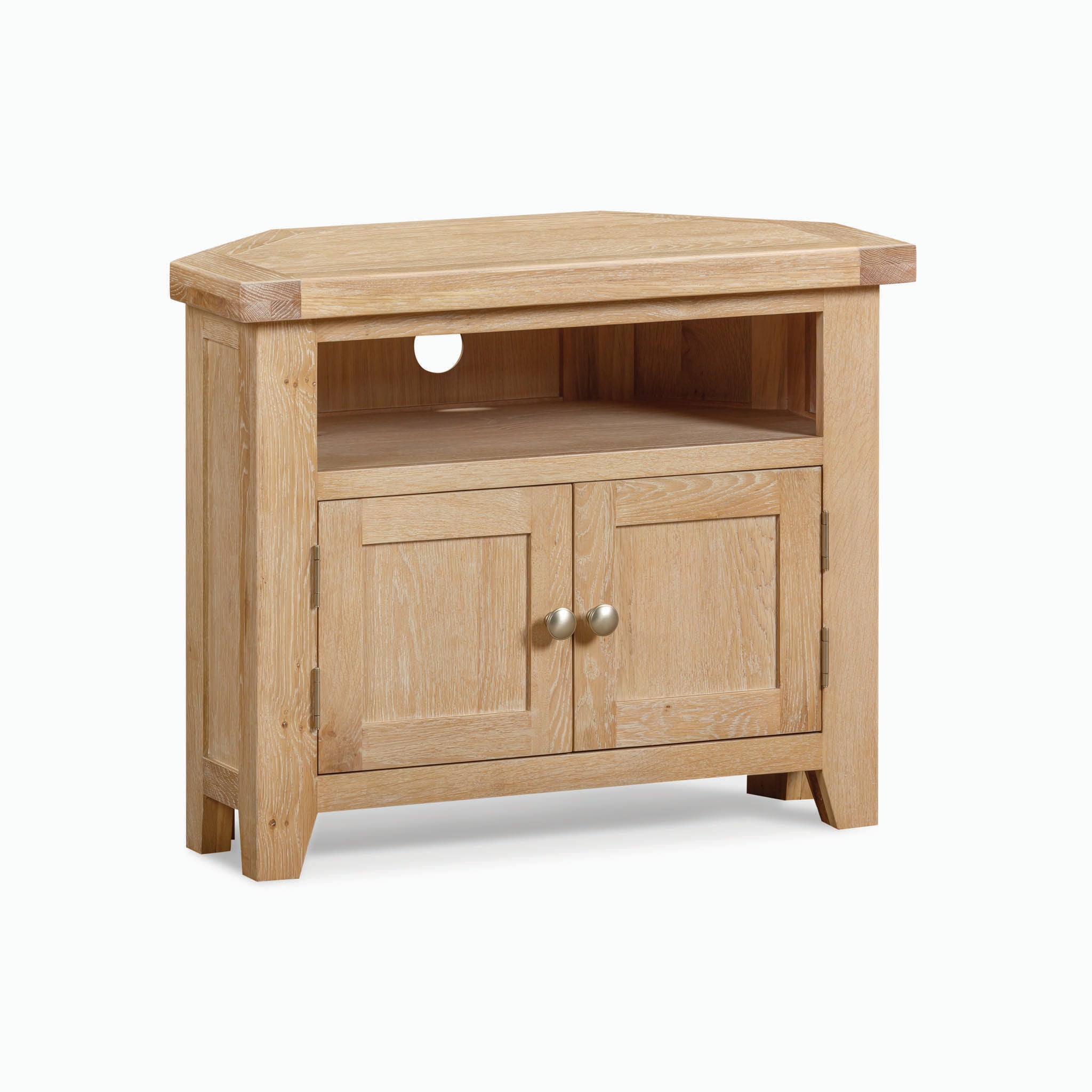 The Burford Corner Media Unit in Natural Oak radiates rustic appeal with its natural oak finish. This wooden corner TV stand includes an open shelf equipped with a cable hole and a cabinet featuring double doors beneath, ideal for organized storage.