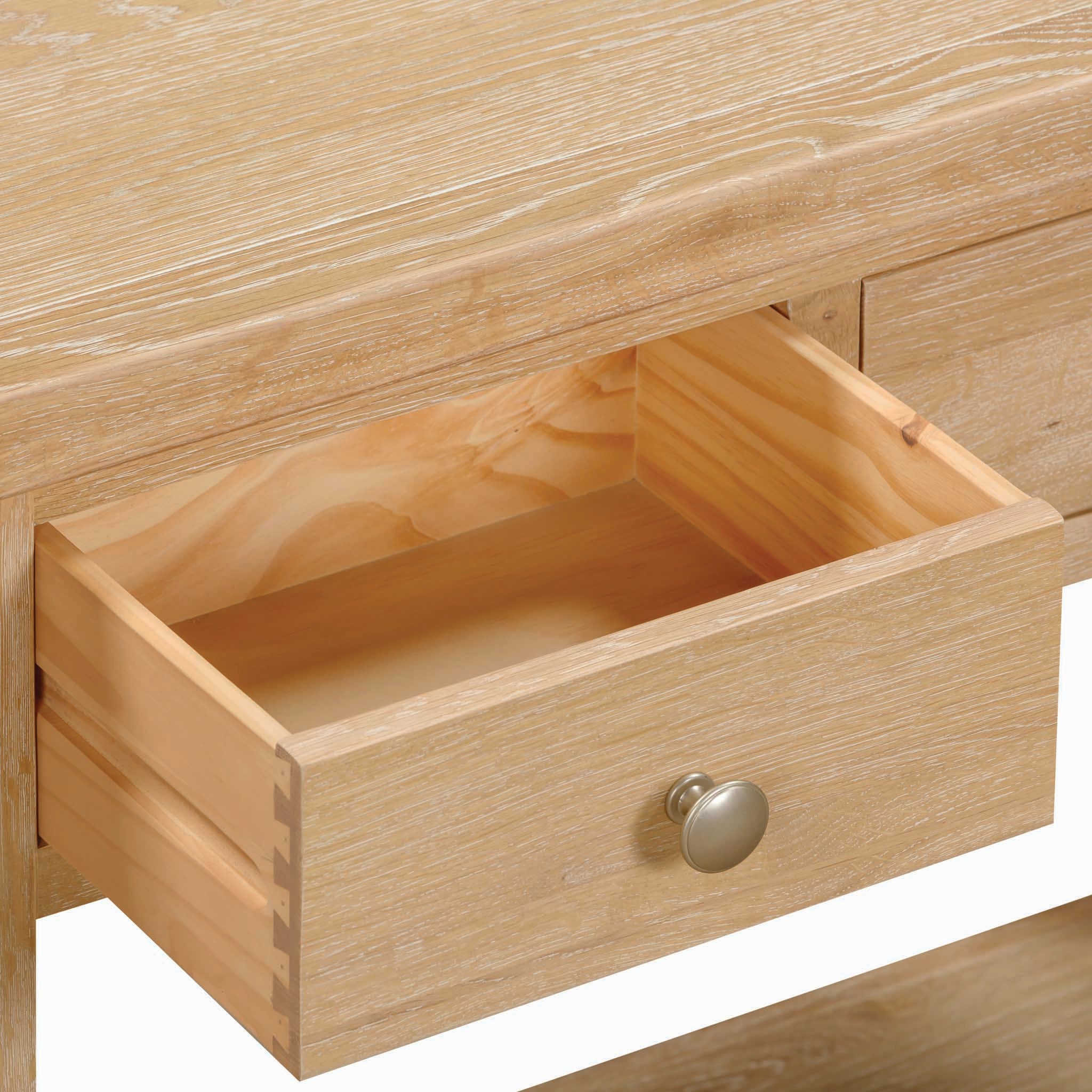 Open the Burford 2 Drawers Console Table in Natural Oak drawer with a round silver knob, partially pulled out from the light wood console table.