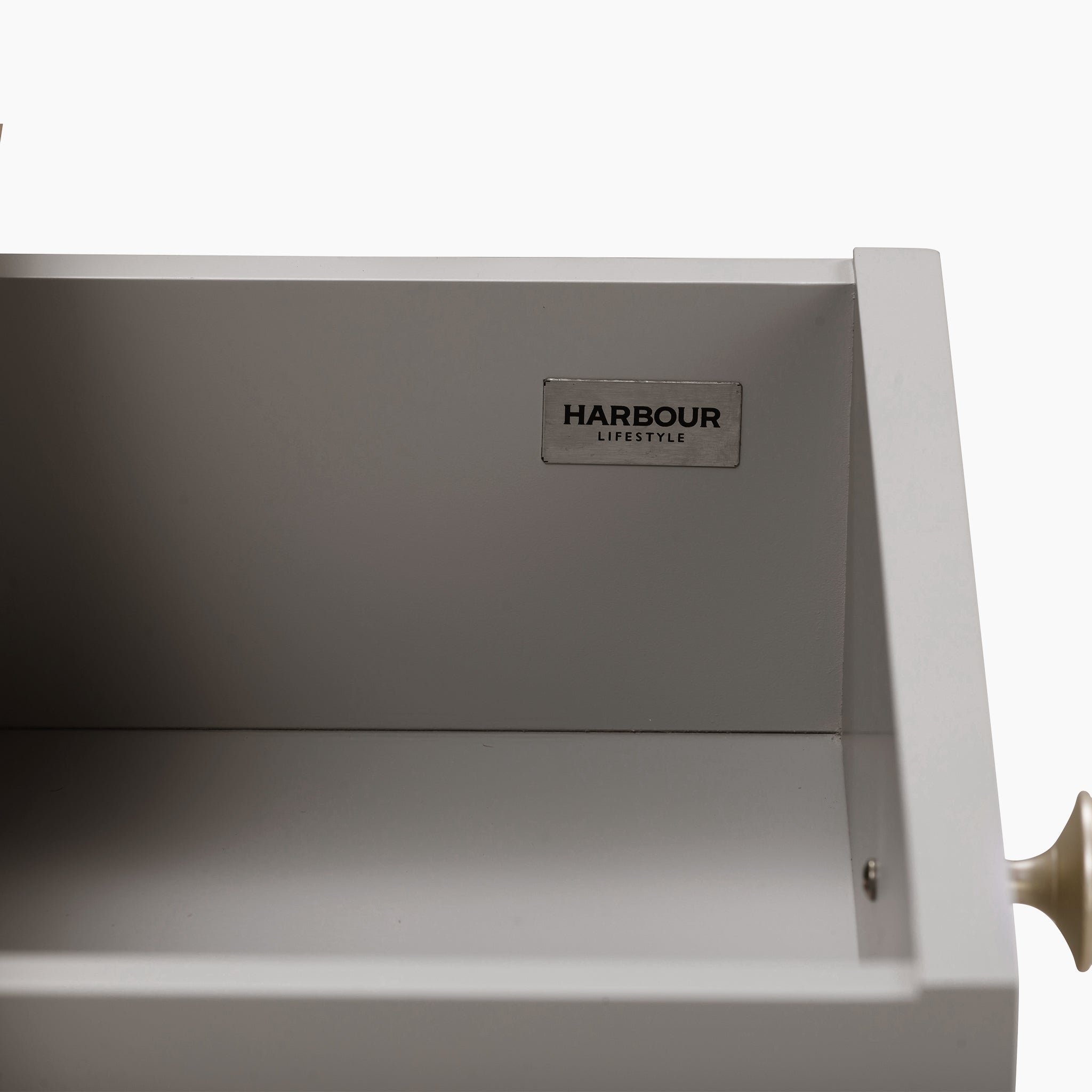 Open a drawer featuring a white interior and marked with the "Harbour Lifestyle" label, perfectly complementing the Pebble Grey finish of the Burford 2 Drawers Console Table.