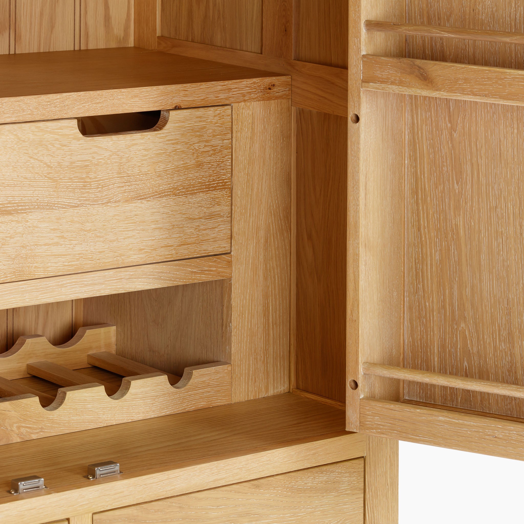 Experience the rustic charm of the Burford Double Larder Unit in Natural Oak, an open wooden cabinet with shelves, drawers, and a built-in wine rack that combines functionality with timeless elegance.