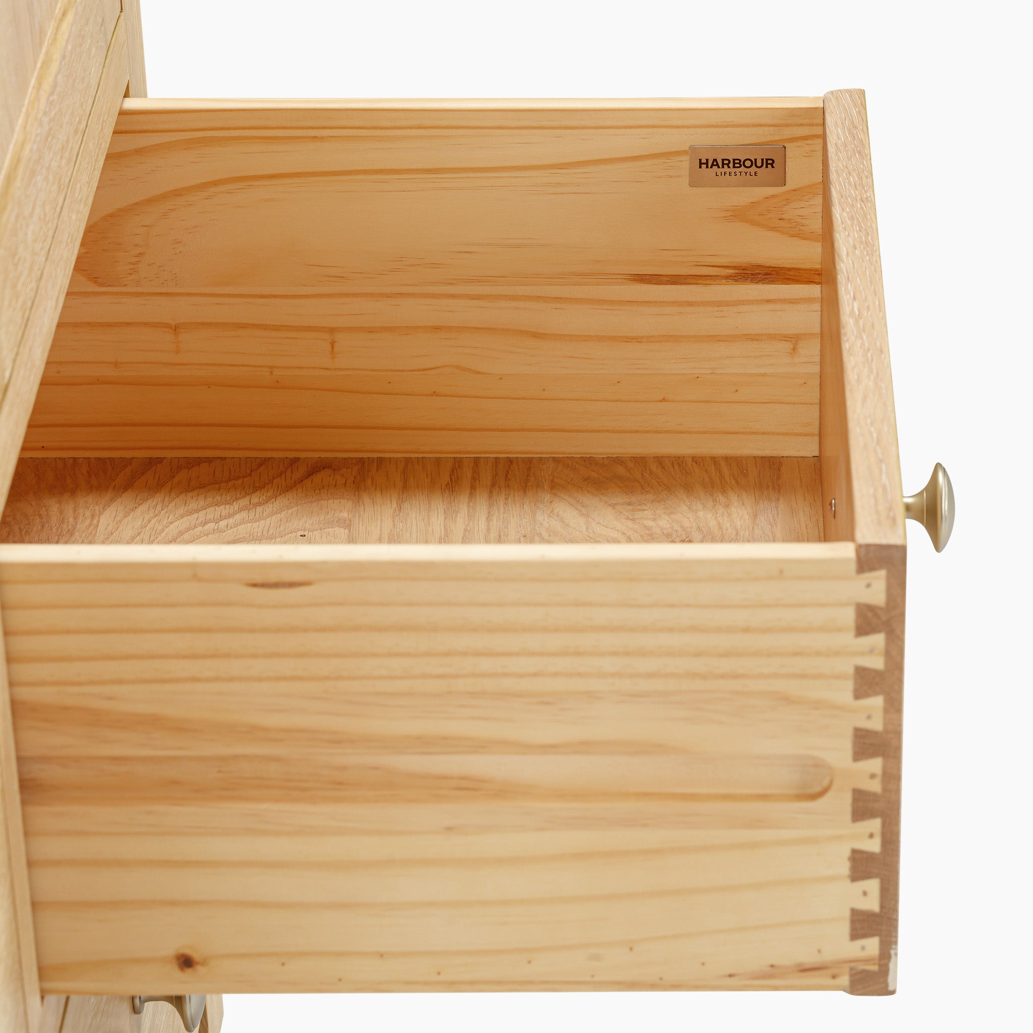 The Burford Double Larder Unit in Natural Oak highlights an open drawer made from natural oak wood with dovetail joints, complete with a brass knob on the right side.