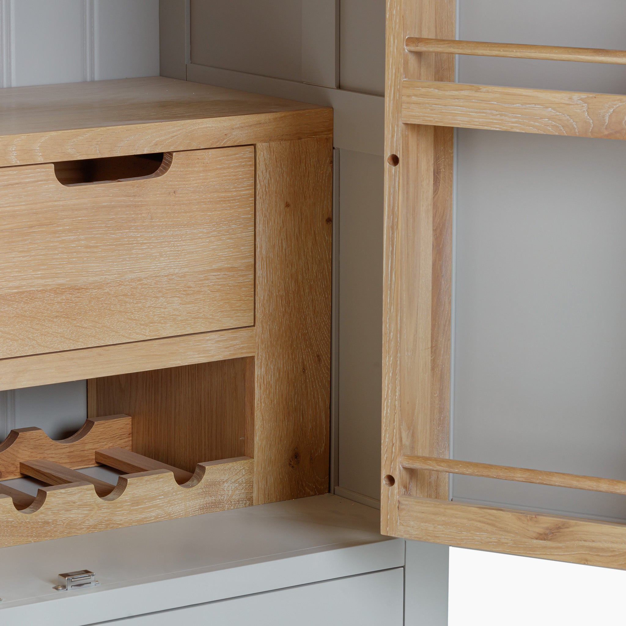 Explore the Burford Double Larder Unit in Pebble Grey, an elegant cabinet crafted from premium natural oak with an open door design. It includes wine racks and drawers, ideal for storage and organization.