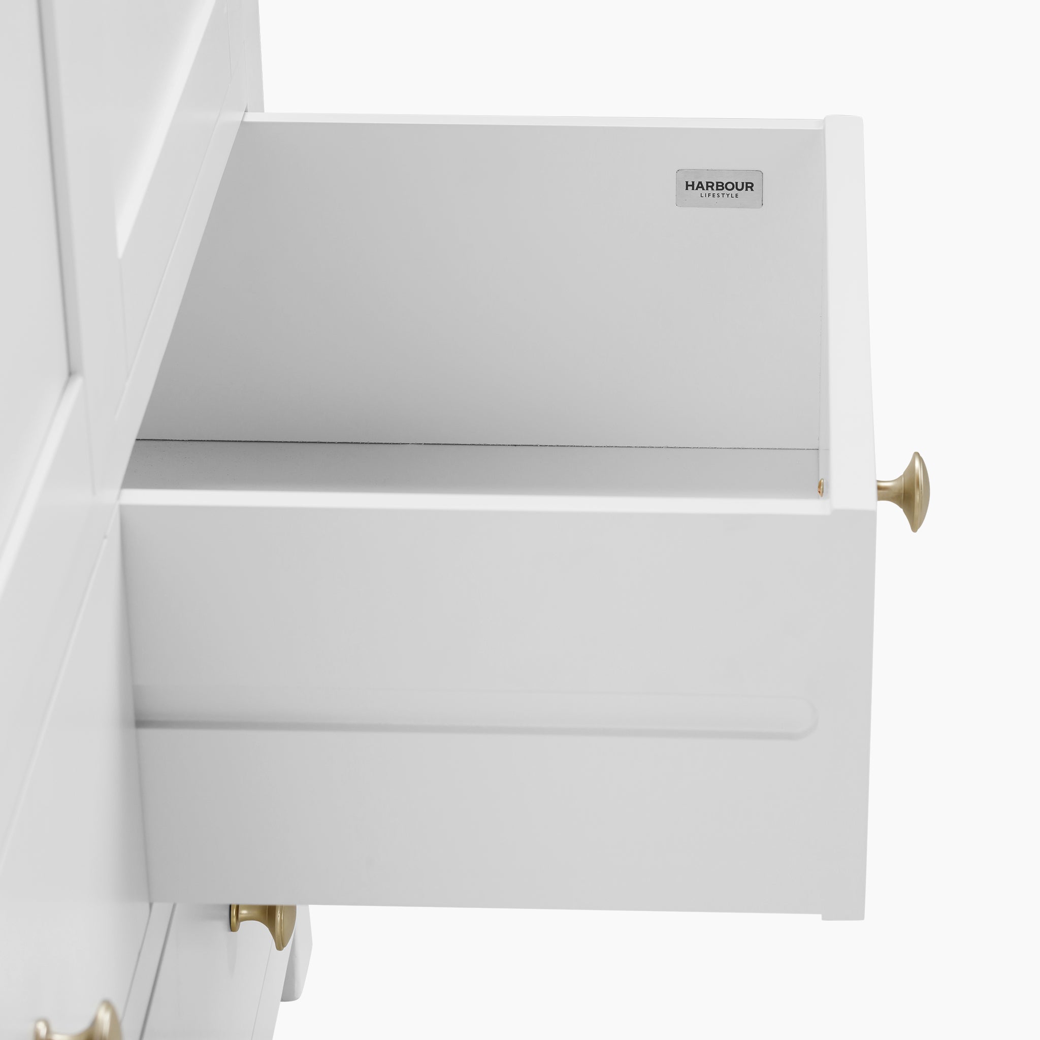 The Burford Double Larder Unit in Warm White boasts an open white drawer adorned with brass handles, ideal for enhancing storage and organization. Its sophisticated design is highlighted by natural oak accents, set against a plain background, making it a stylish yet practical addition to any room.