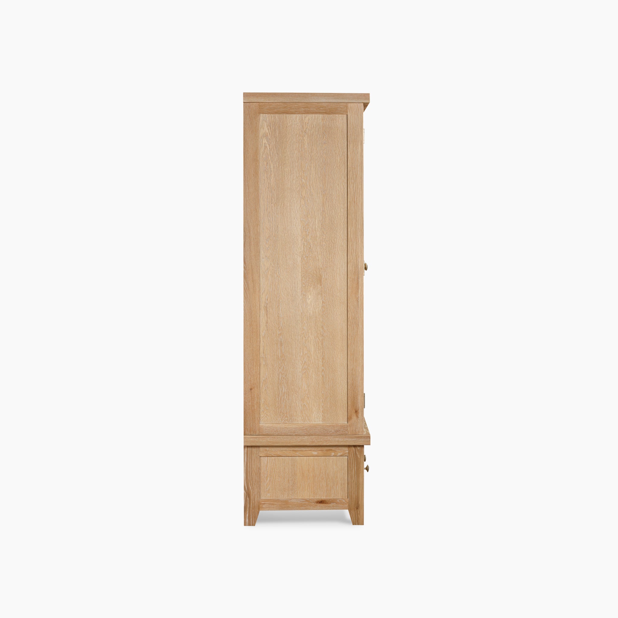 Side view of the Burford Double Wardrobe with Drawer in Natural Oak, showcasing a tall, light wooden design with a bottom drawer and closed doors.