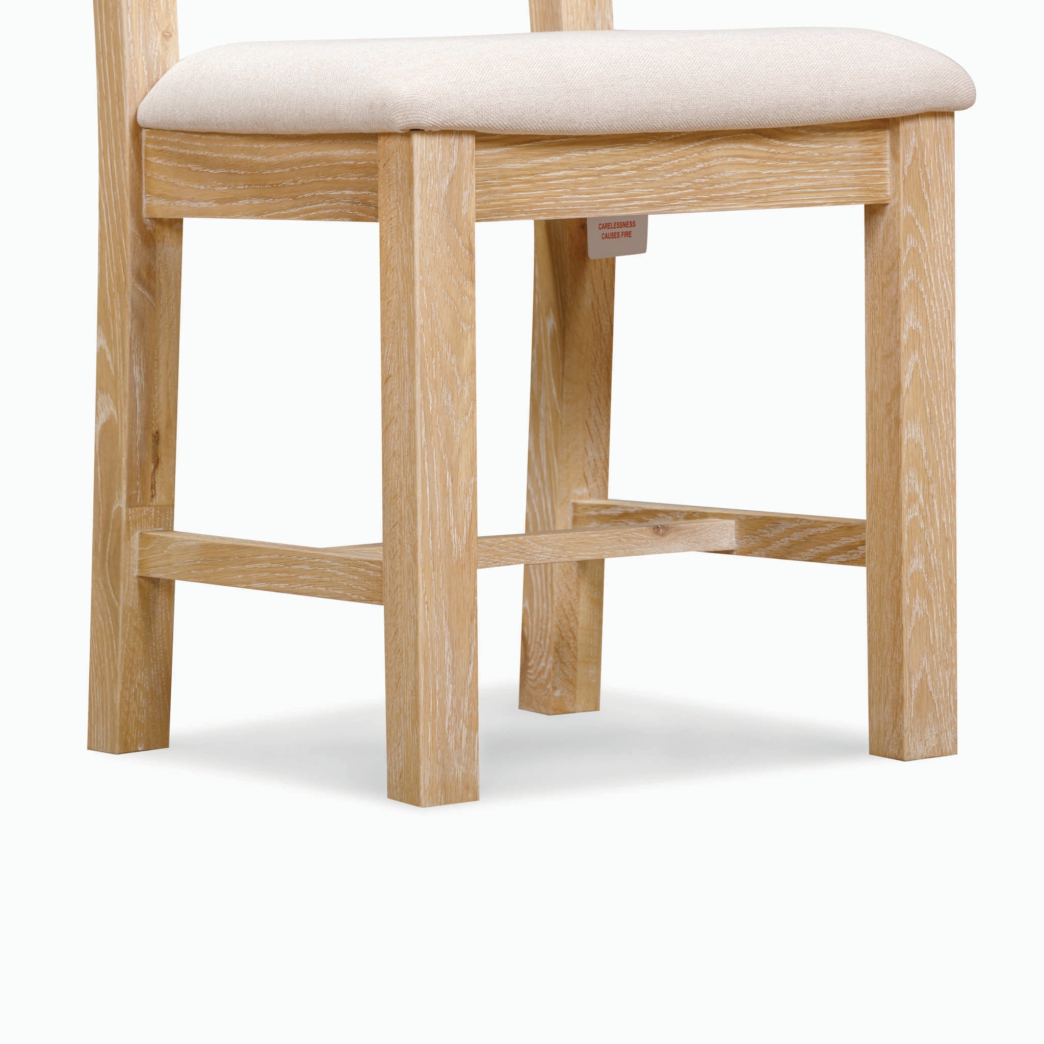 A Burford Ladderback Dining Chair with a beige upholstered seat in natural oak, showcasing a minimalist design against a plain white background.