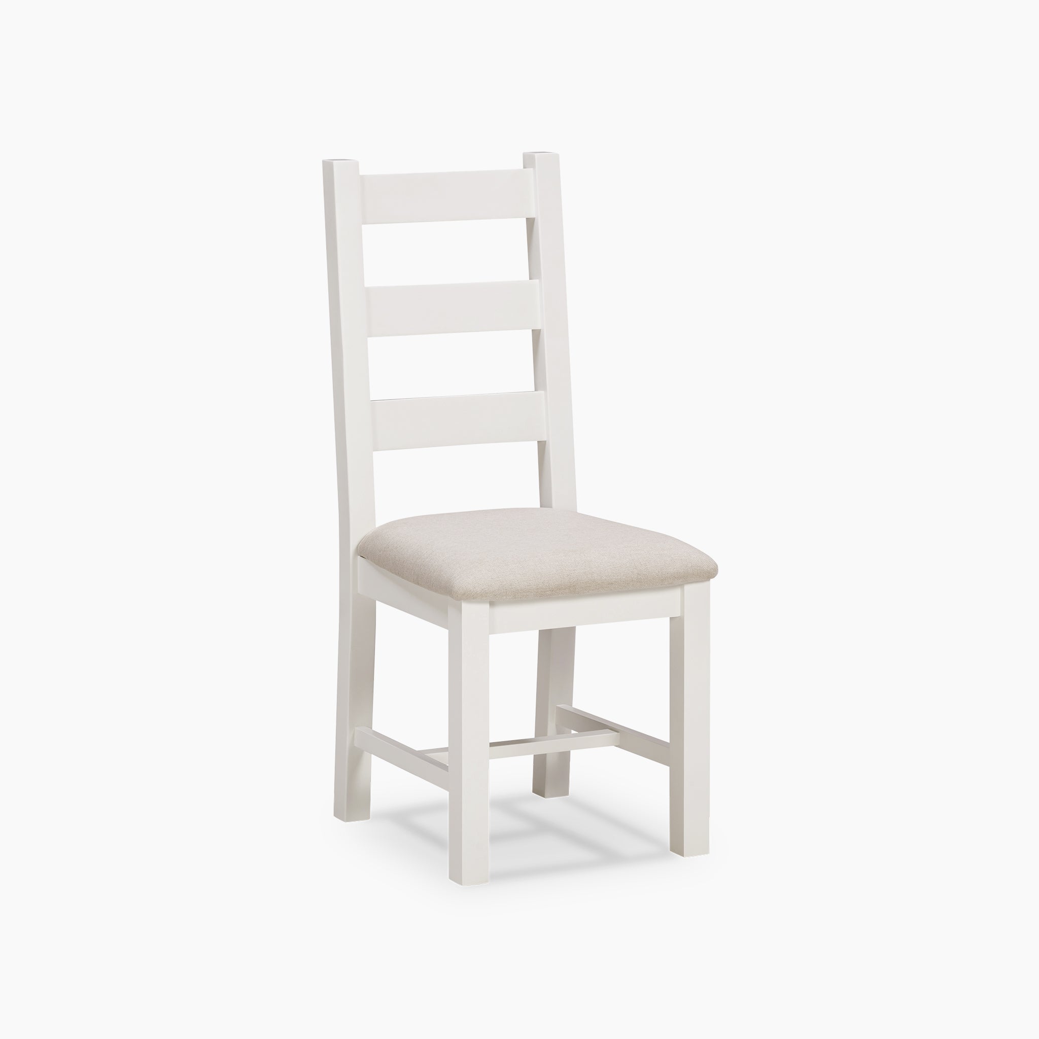 The Burford Set of 2 Ladderback Dining Chairs with Fabric Seat in Warm White showcases a timeless design, featuring a warm white finish complemented by beige cushioned seats that beautifully highlight the essence of natural oak. The elegant ladder back design stands out distinctly against a plain white background.