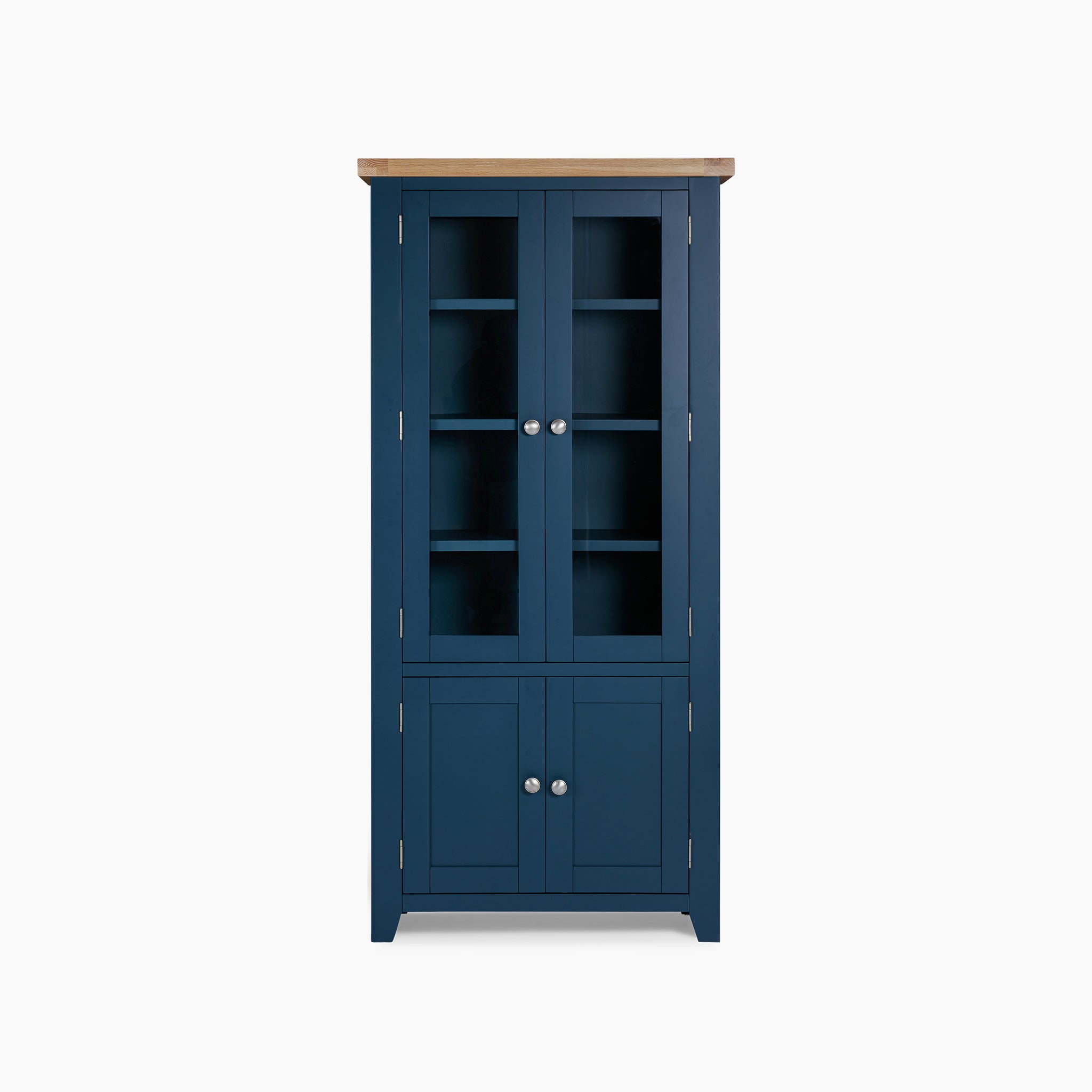 The Burford Display Cabinet in Navy Blue is a striking piece, showcasing navy blue wooden framing with a natural oak top and elegant glass-paneled doors, perfectly complementing any white backdrop.