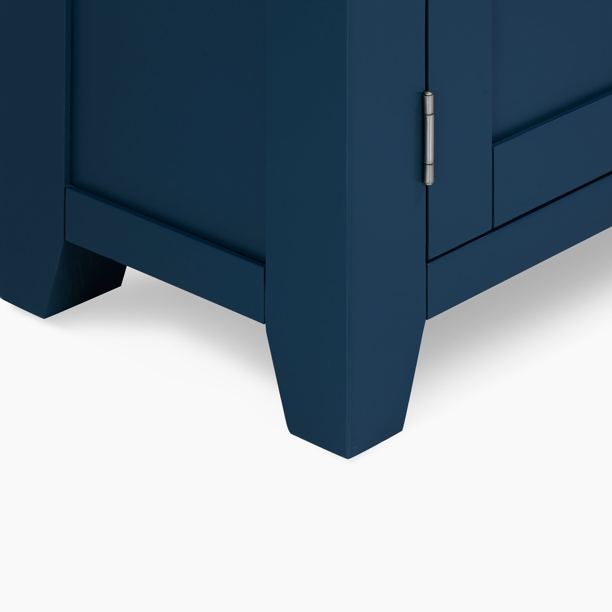 This close-up highlights the corner of the Burford Display Cabinet in Navy Blue, showcasing its elegant metal hinge and tapered legs, which seamlessly blend style with functionality.