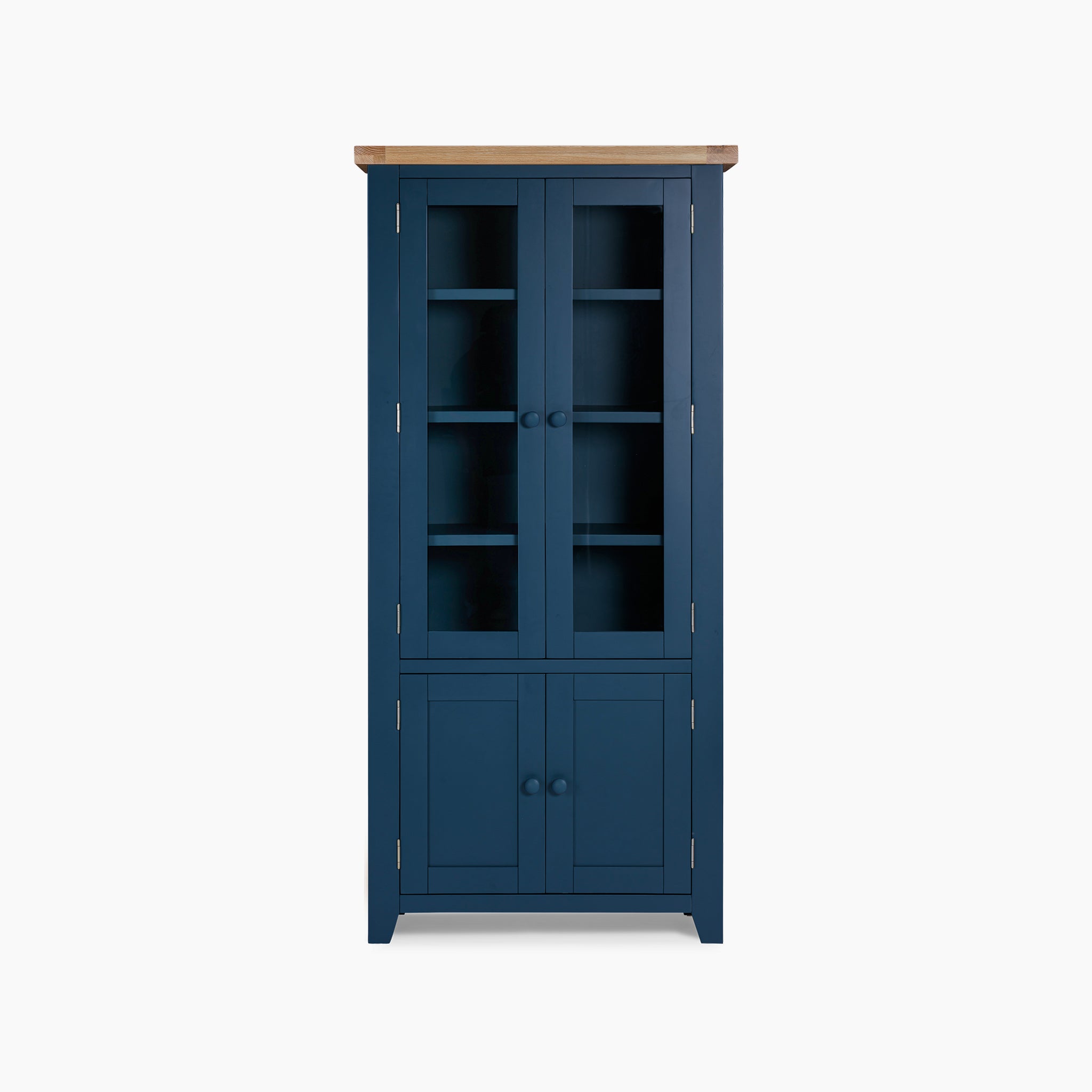 The Burford Display Cabinet in Navy Blue features a natural oak top, with glass-paneled upper doors and solid lower doors, all set against a plain backdrop.