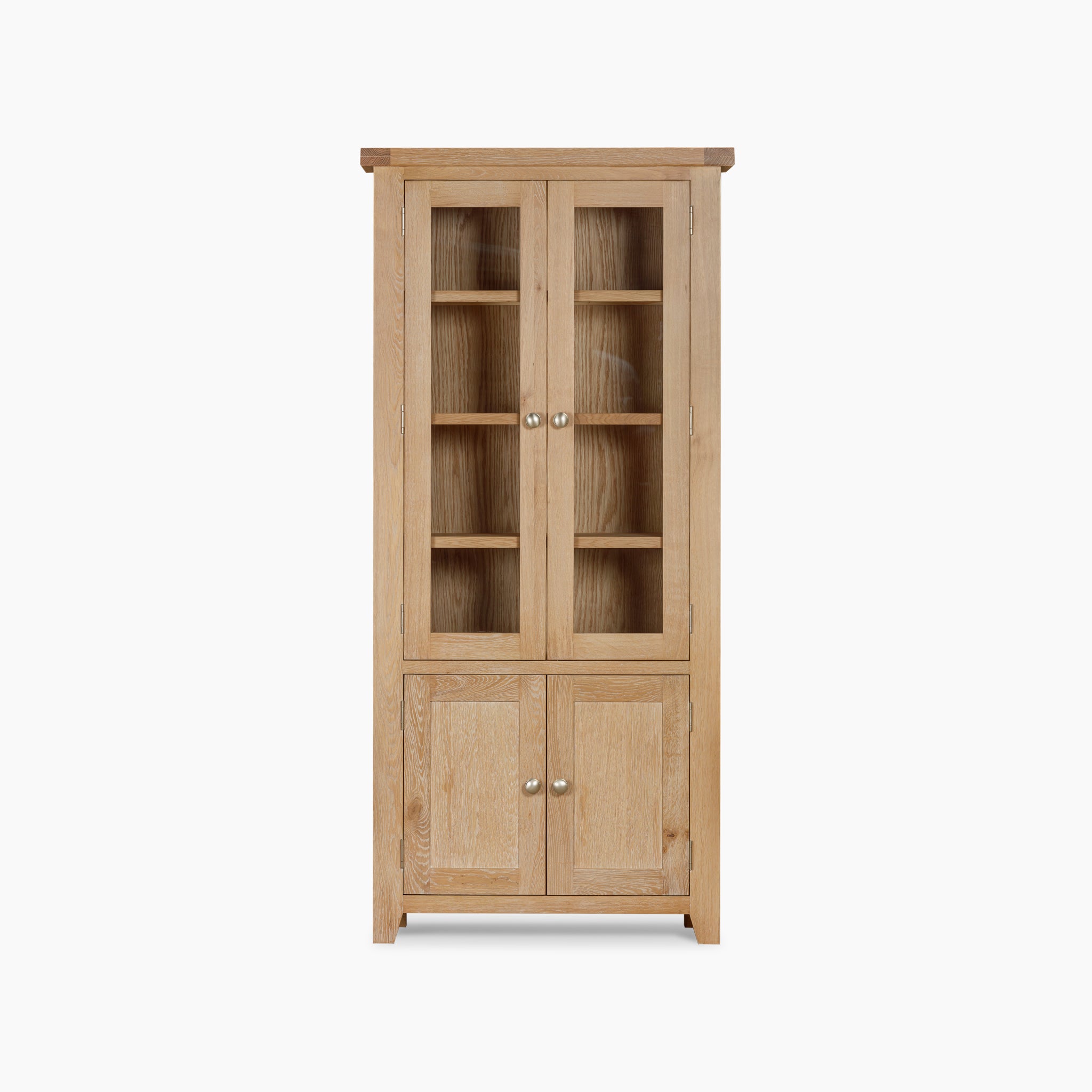 The Burford Display Cabinet in Natural Oak features glass-panelled doors on the upper section, paired with solid doors below.